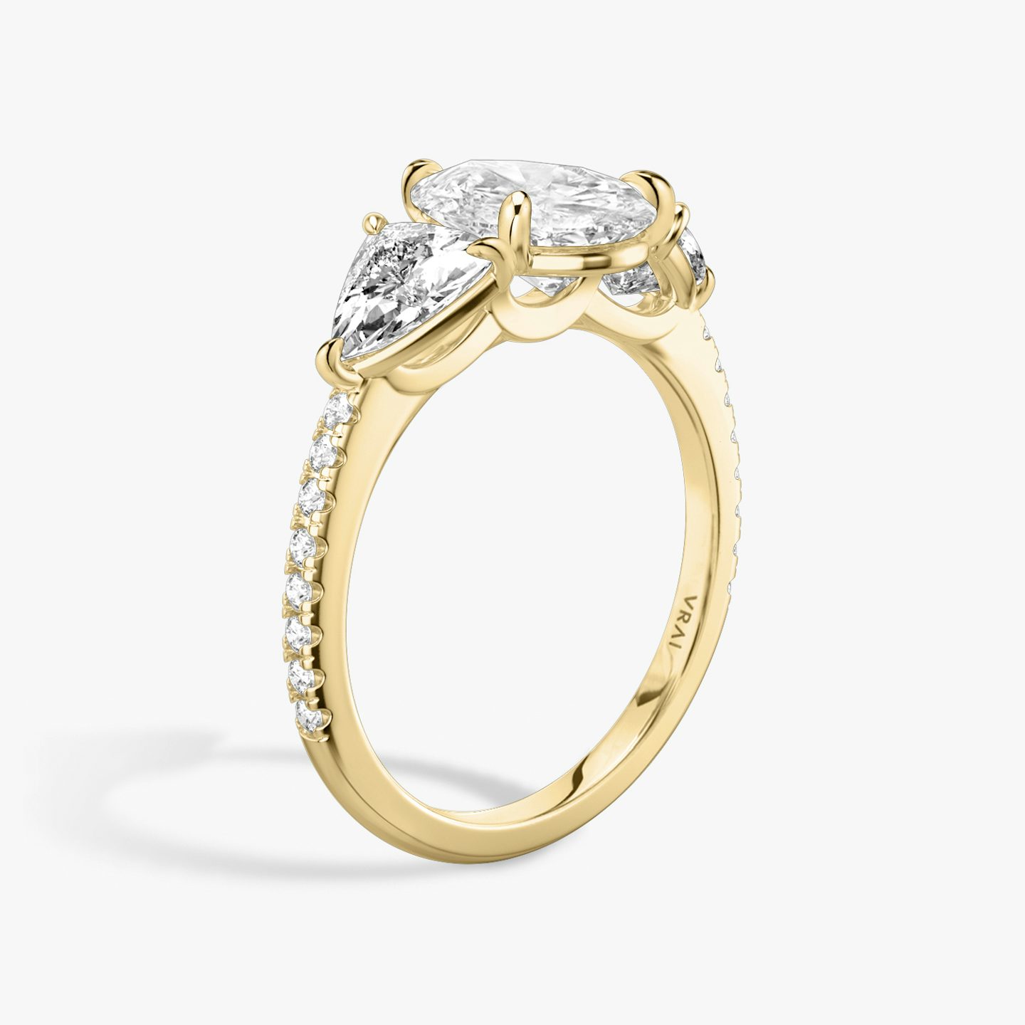 The Three Stone | Pear | 18k | 18k Yellow Gold | Band: Pavé | Side stone carat: 1/2 | Side stone shape: Trillion | Diamond orientation: vertical | Carat weight: See full inventory