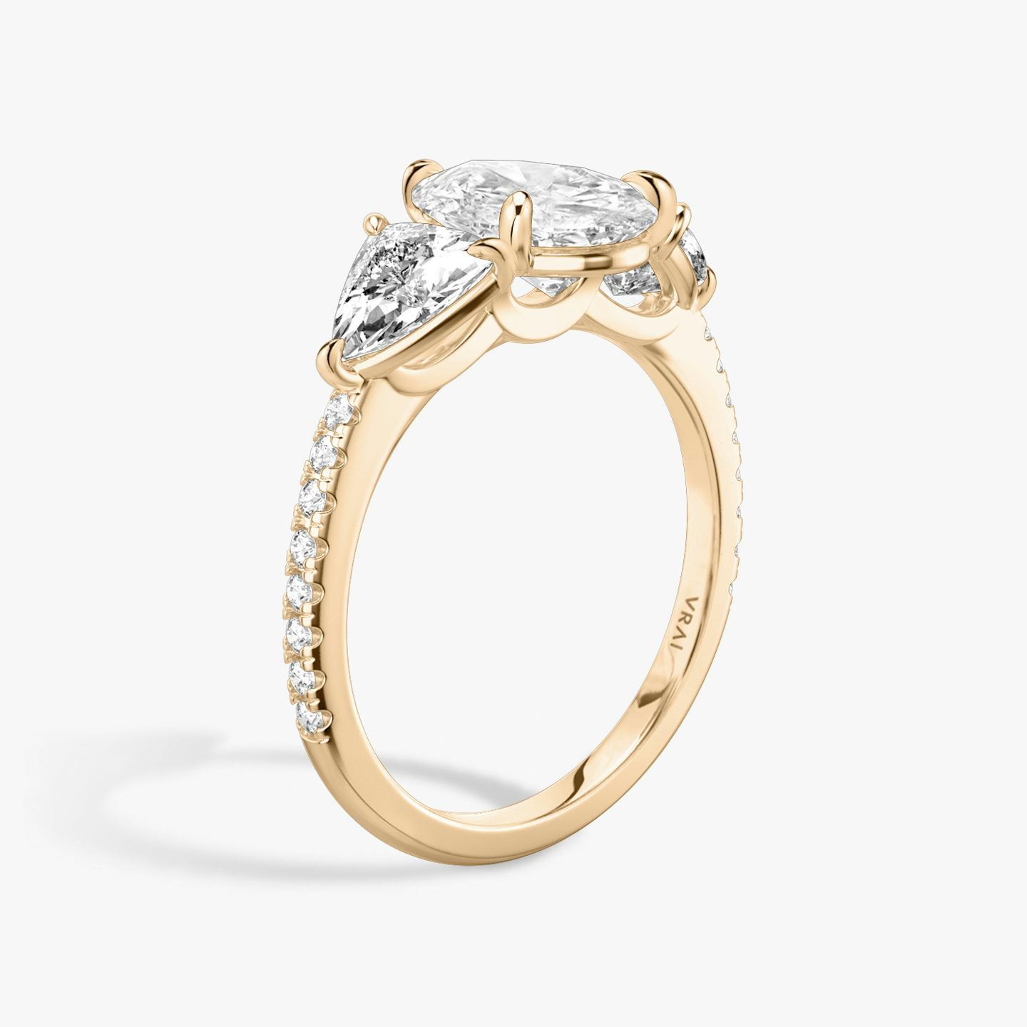 The Three Stone | Pear | 14k | 14k Rose Gold | Band: Pavé | Side stone carat: 1/2 | Side stone shape: Trillion | Diamond orientation: vertical | Carat weight: See full inventory