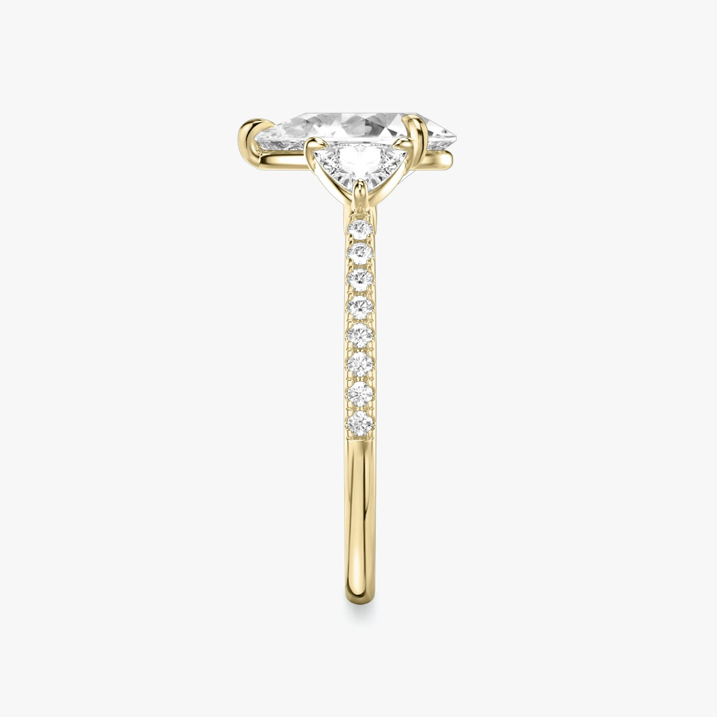 The Three Stone | Pear | 18k | 18k Yellow Gold | Band: Pavé | Side stone carat: 1/4 | Side stone shape: Trillion | Diamond orientation: vertical | Carat weight: See full inventory