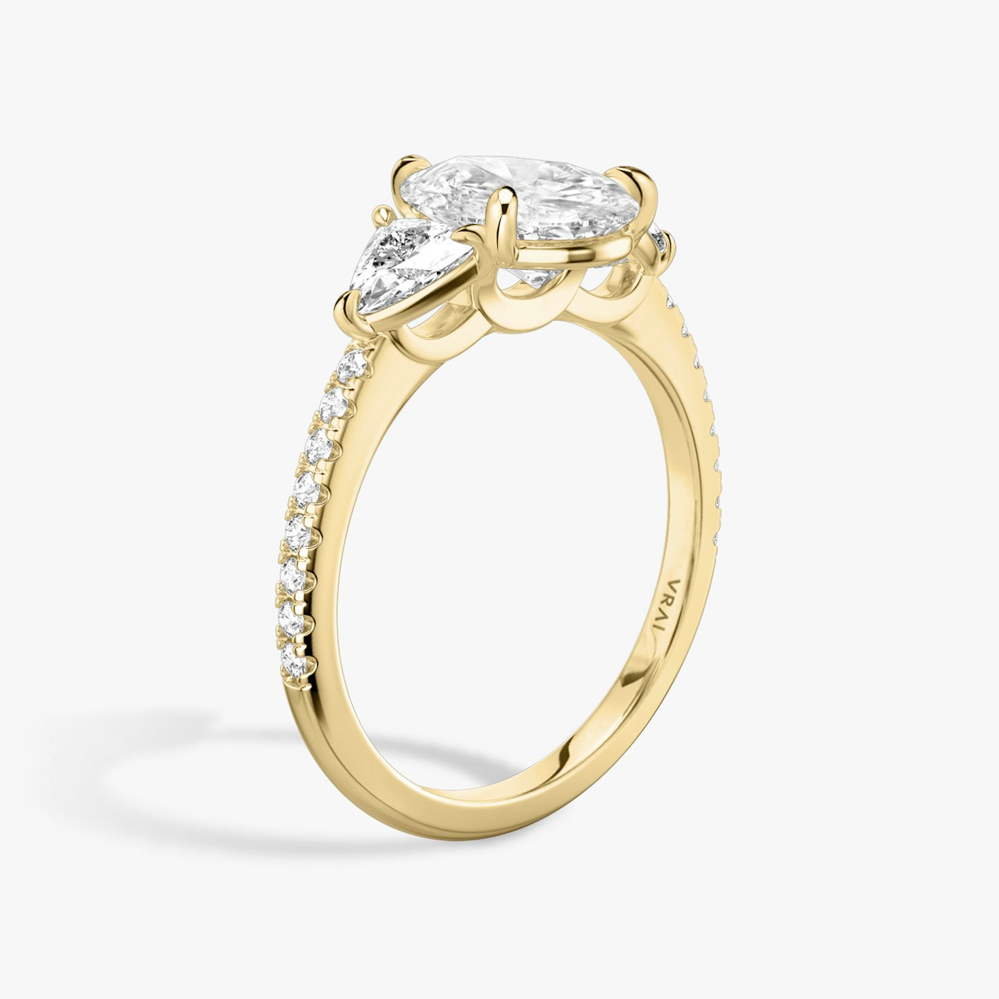 The Three Stone | Pear | 18k | 18k Yellow Gold | Band: Pavé | Side stone carat: 1/4 | Side stone shape: Trillion | Diamond orientation: vertical | Carat weight: See full inventory