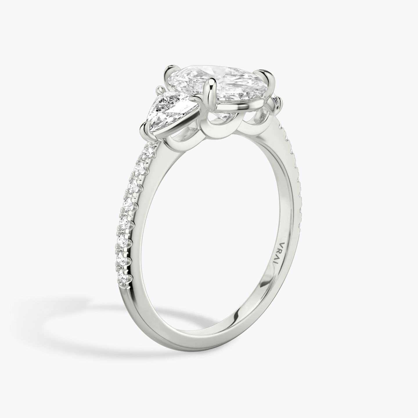 The Three Stone | Pear | Platinum | Band: Pavé | Side stone carat: 1/4 | Side stone shape: Trillion | Diamond orientation: vertical | Carat weight: See full inventory