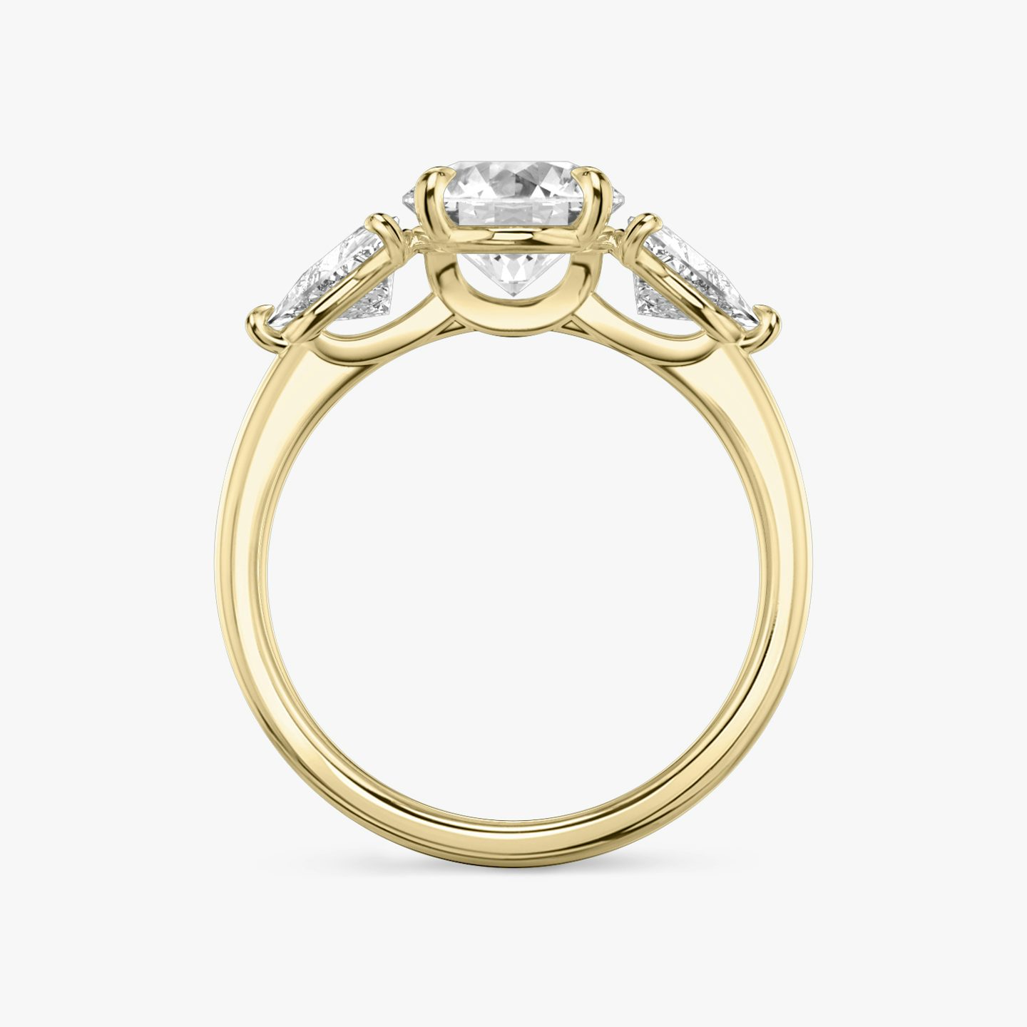 The Three Stone | Round Brilliant | 18k | 18k Yellow Gold | Band: Plain | Carat weight: See full inventory | Side stone carat: 1/2 | Side stone shape: Trillion | Diamond orientation: vertical