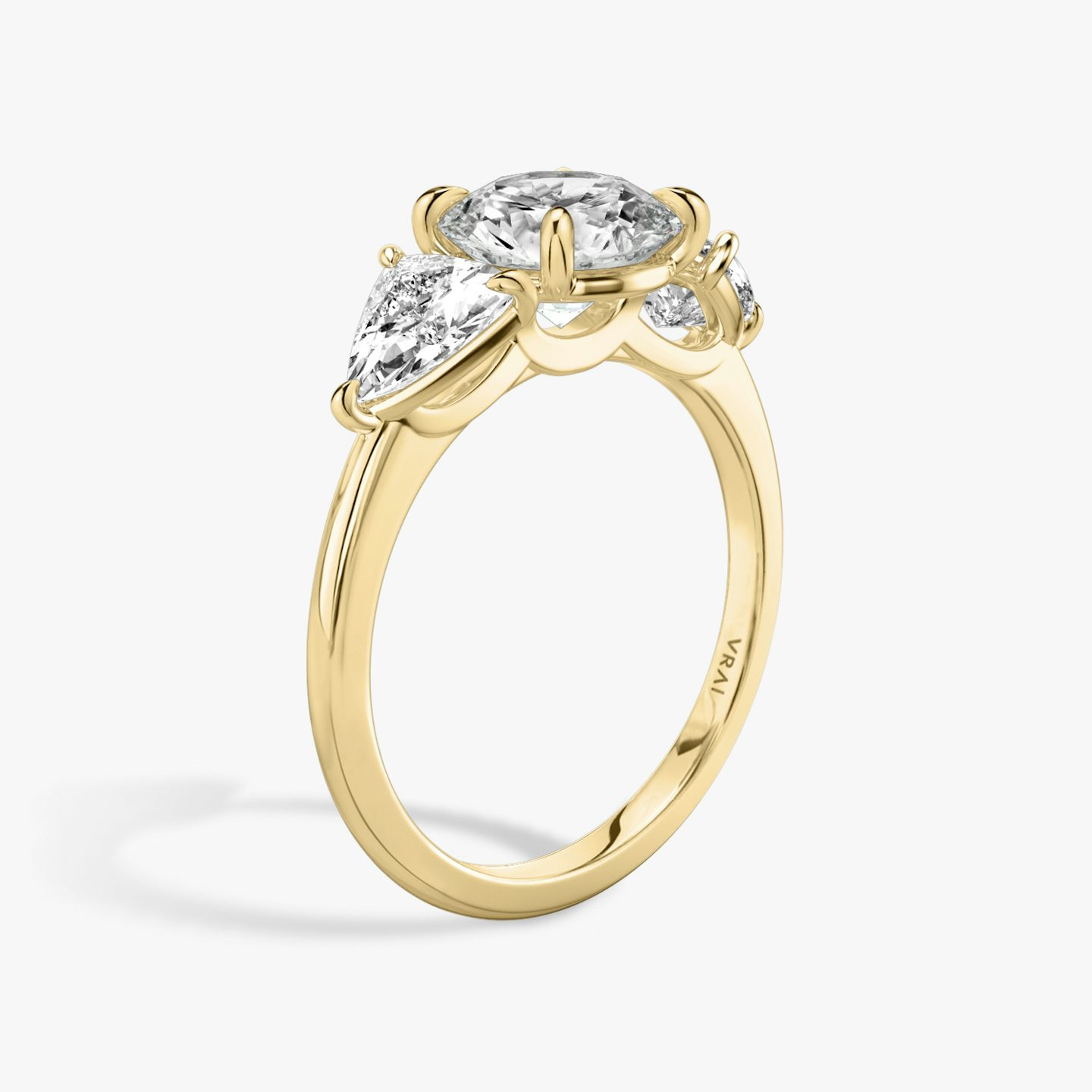 The Three Stone | Round Brilliant | 18k | 18k Yellow Gold | Band: Plain | Carat weight: See full inventory | Side stone carat: 1/2 | Side stone shape: Trillion | Diamond orientation: vertical