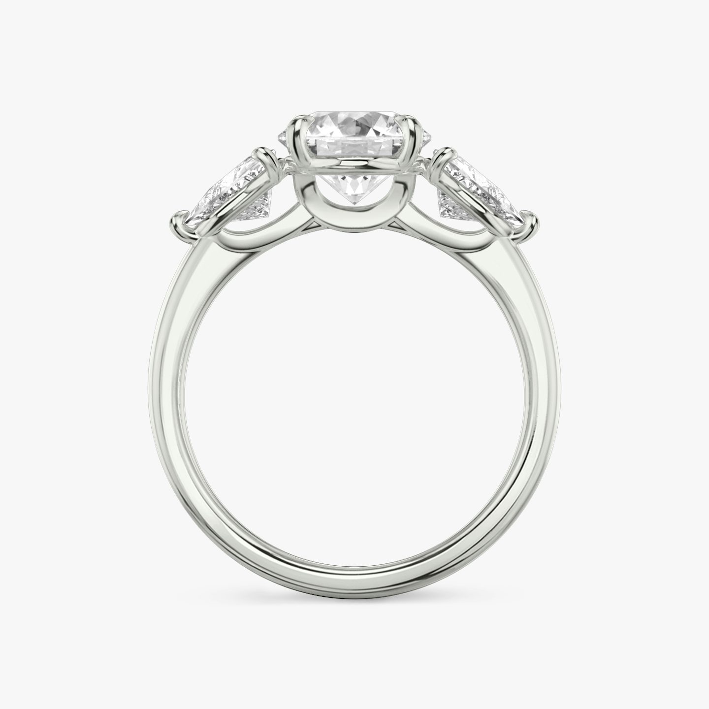 The Three Stone | Round Brilliant | 18k | 18k White Gold | Band: Plain | Carat weight: See full inventory | Side stone carat: 1/2 | Side stone shape: Trillion | Diamond orientation: vertical