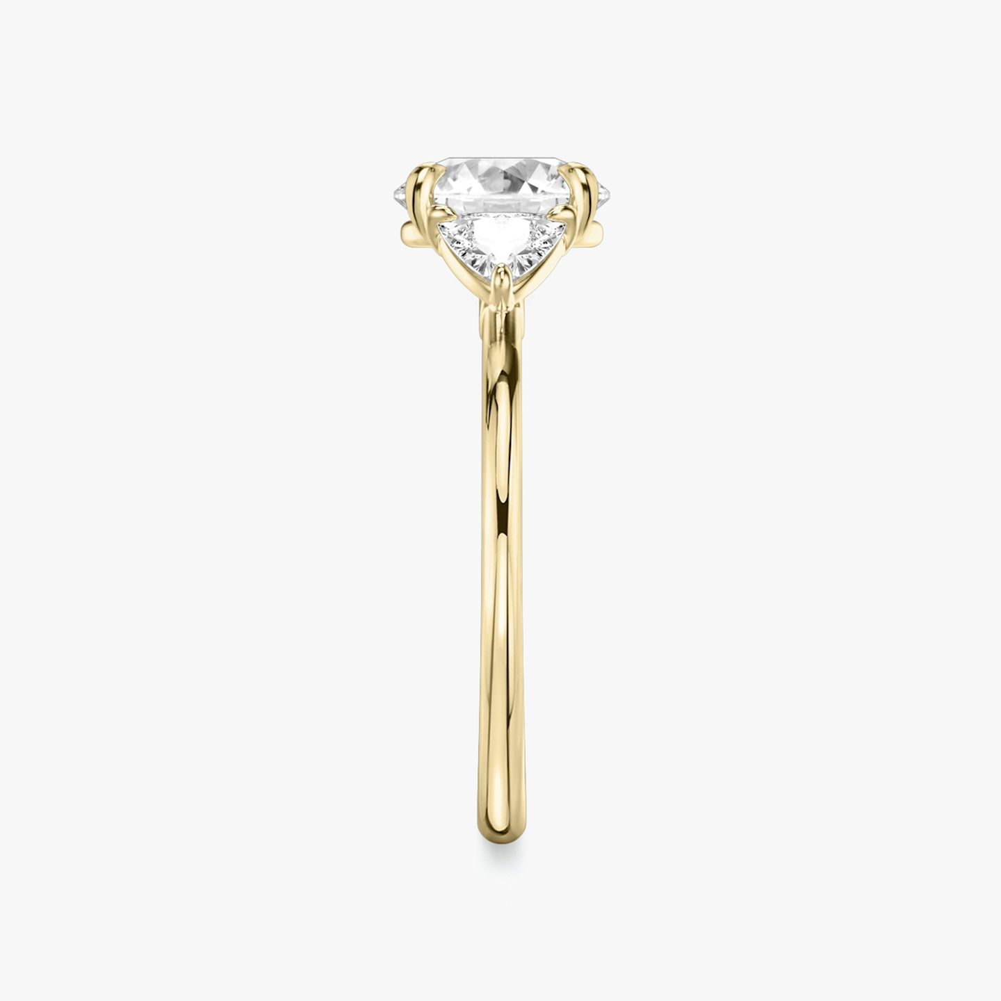 The Three Stone | Round Brilliant | 18k | 18k Yellow Gold | Band: Plain | Carat weight: See full inventory | Side stone carat: 1/4 | Side stone shape: Trillion | Diamond orientation: vertical