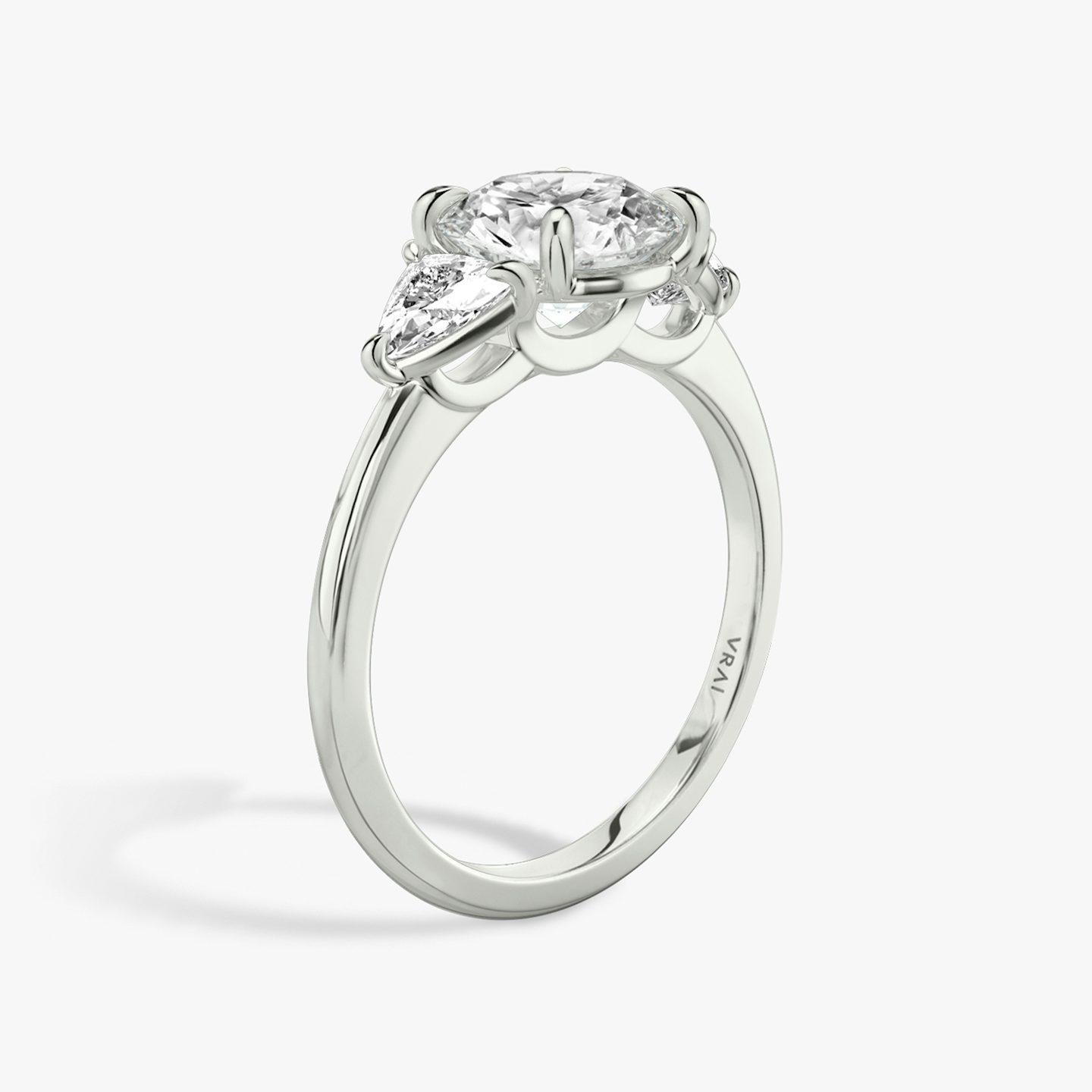 The Three Stone | Round Brilliant | 18k | 18k White Gold | Band: Plain | Carat weight: See full inventory | Side stone carat: 1/4 | Side stone shape: Trillion | Diamond orientation: vertical