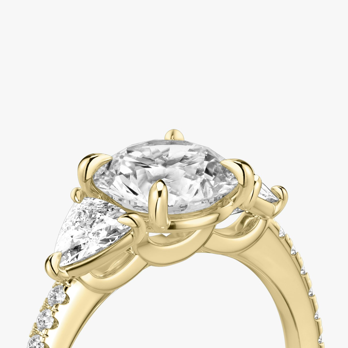 The Three Stone | Round Brilliant | 18k | 18k Yellow Gold | Band: Pavé | Carat weight: See full inventory | Side stone carat: 1/4 | Side stone shape: Trillion | Diamond orientation: vertical