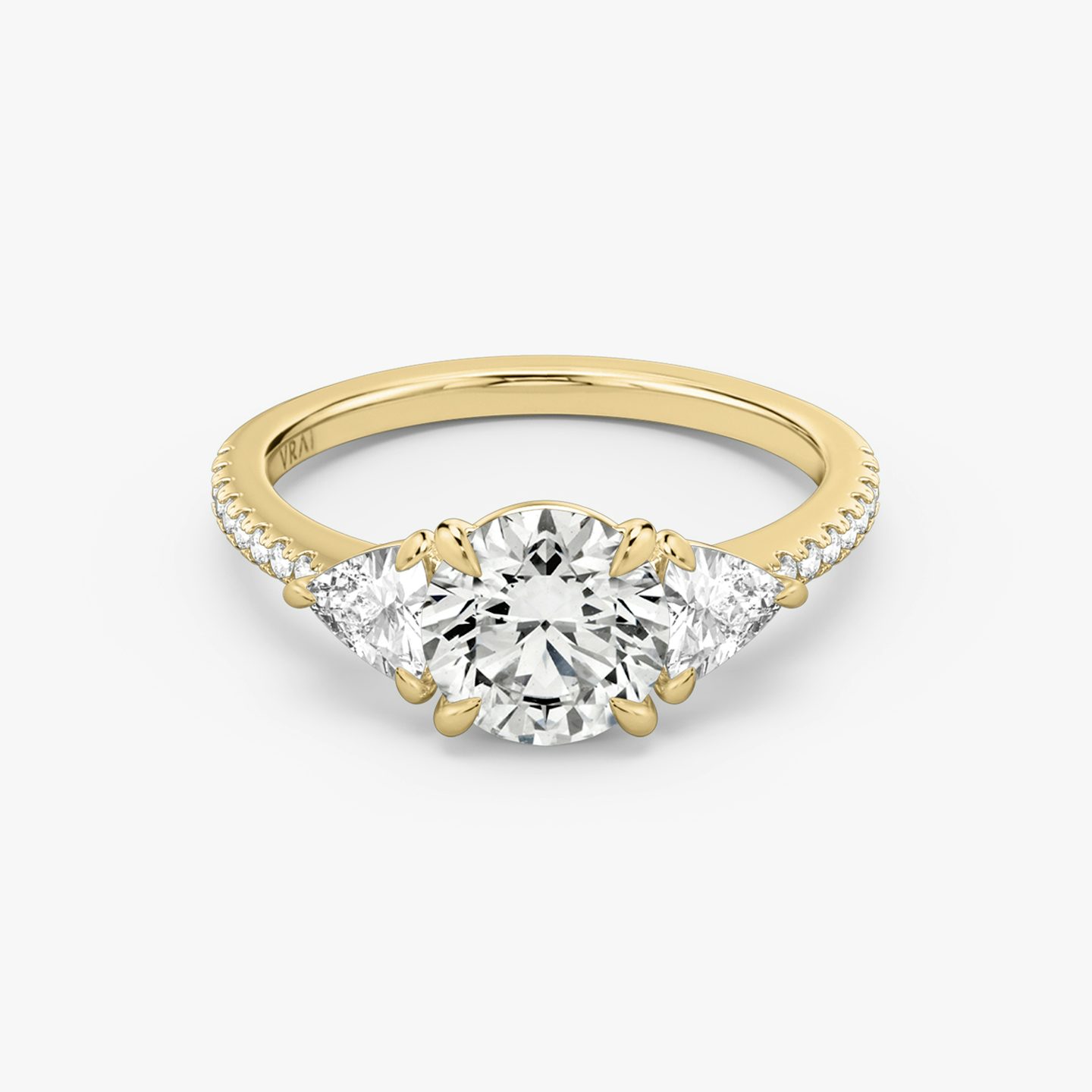 The Three Stone | Round Brilliant | 18k | 18k Yellow Gold | Band: Pavé | Carat weight: See full inventory | Side stone carat: 1/4 | Side stone shape: Trillion | Diamond orientation: vertical