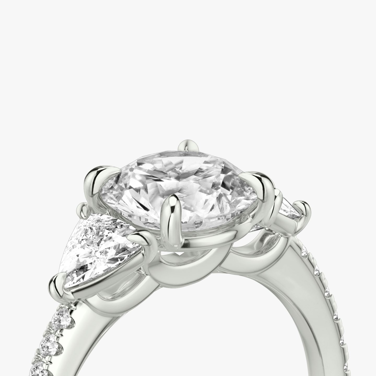 The Three Stone | Round Brilliant | 18k | 18k White Gold | Band: Pavé | Carat weight: See full inventory | Side stone carat: 1/4 | Side stone shape: Trillion | Diamond orientation: vertical