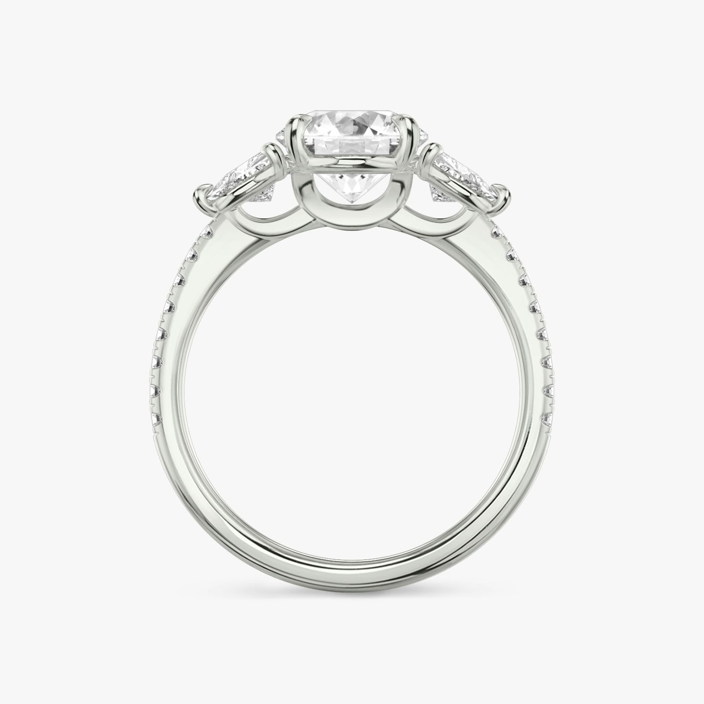 The Three Stone | Round Brilliant | 18k | 18k White Gold | Band: Pavé | Carat weight: See full inventory | Side stone carat: 1/4 | Side stone shape: Trillion | Diamond orientation: vertical