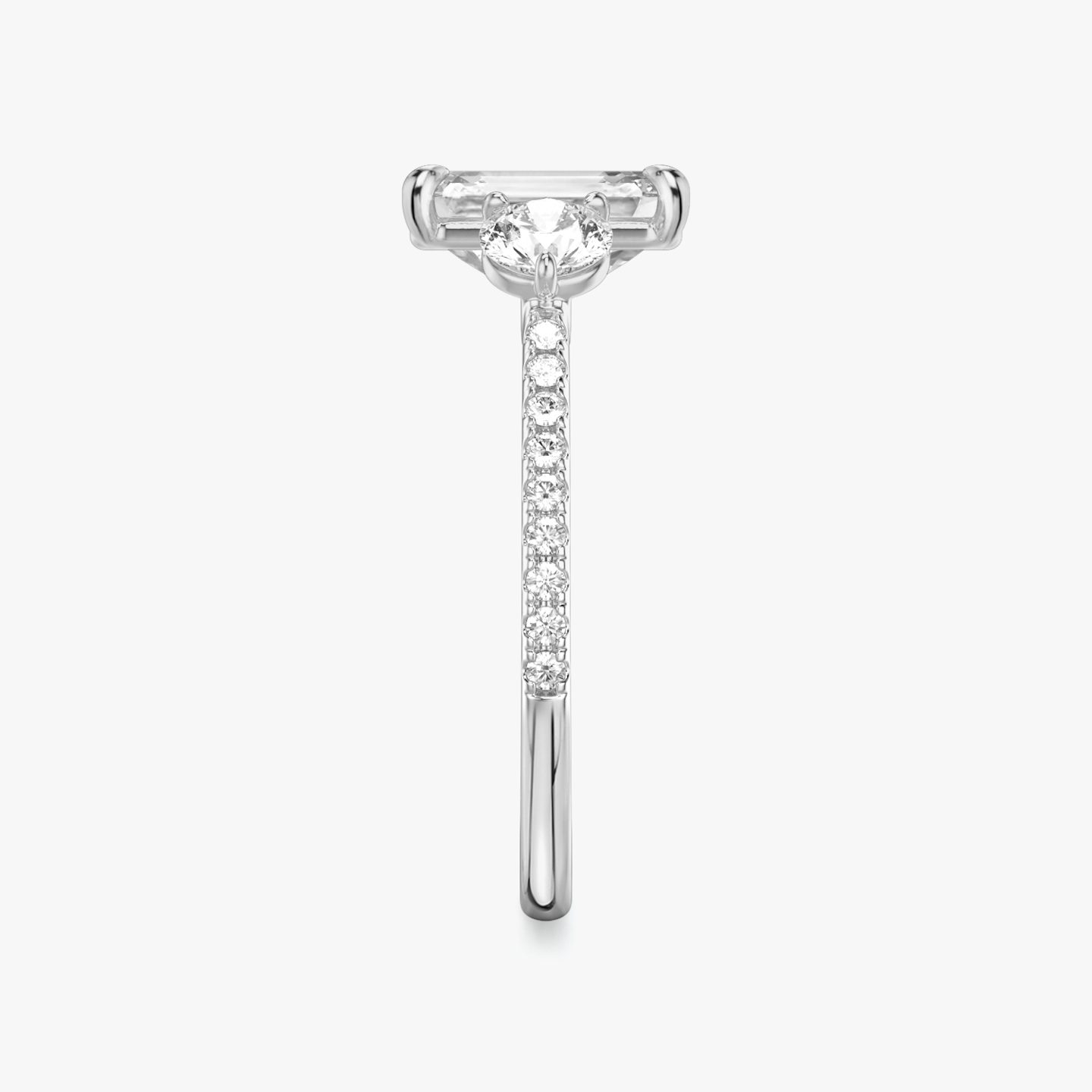 The Three Stone | Emerald | 18k | 18k White Gold | Band: Pavé | Side stone carat: 1/4 | Side stone shape: Round Brilliant | Diamond orientation: vertical | Carat weight: See full inventory
