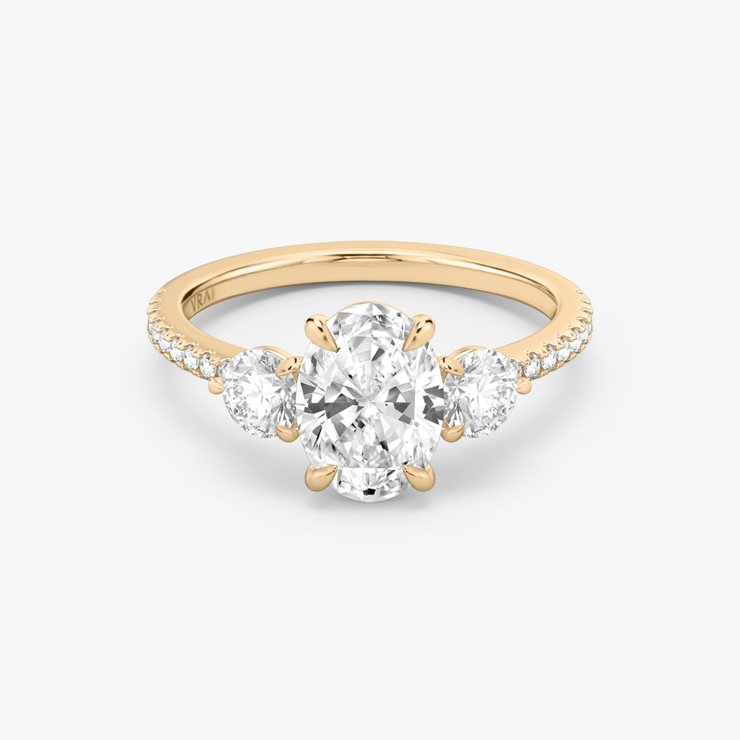 The Three Stone | Oval | 14k | 14k Rose Gold | Band: Pavé | Side stone carat: 1/4 | Side stone shape: Round Brilliant | Diamond orientation: vertical | Carat weight: See full inventory