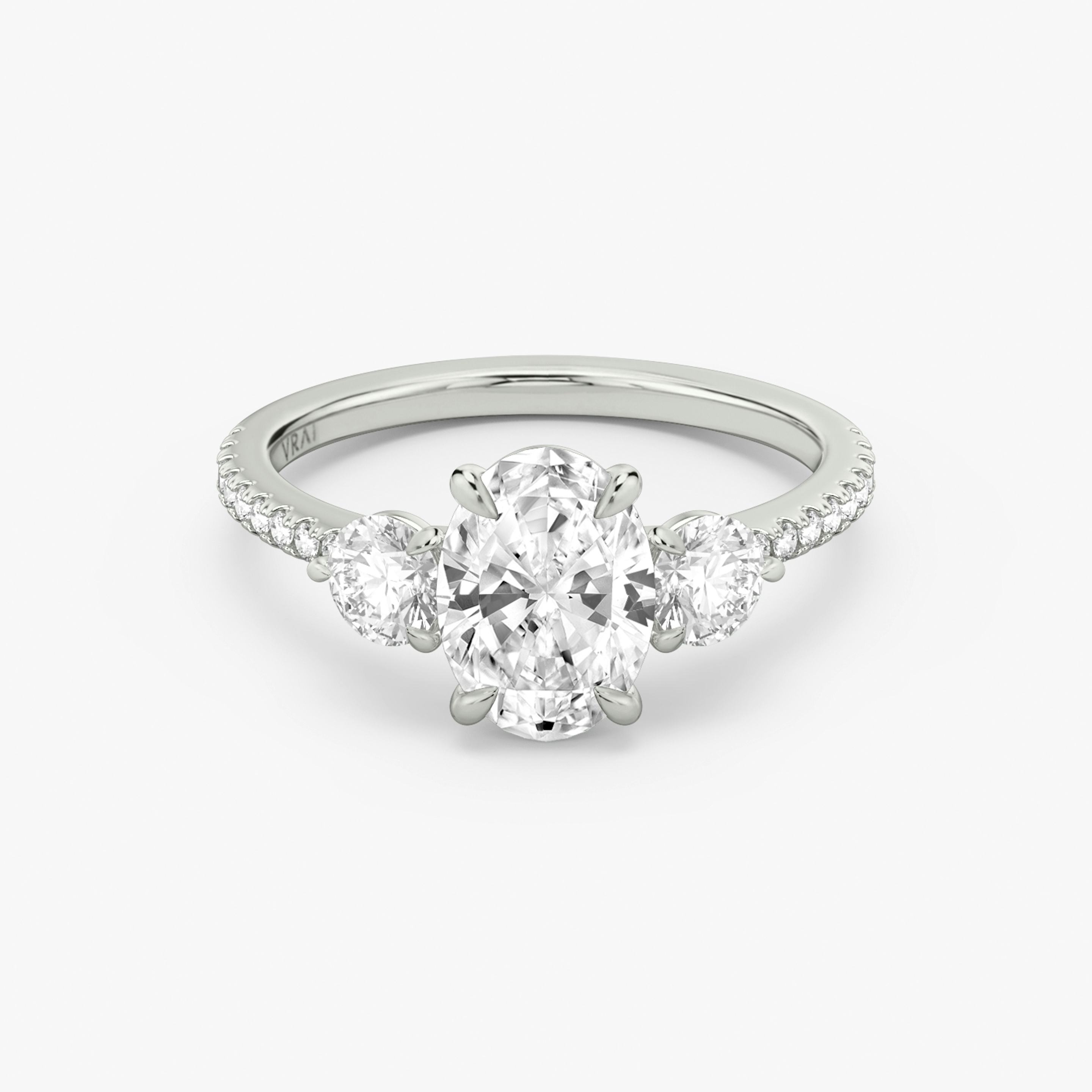 The Three Stone | Oval | Platinum | Band: Pavé | Side stone carat: 1/4 | Side stone shape: Round Brilliant | Diamond orientation: vertical | Carat weight: See full inventory