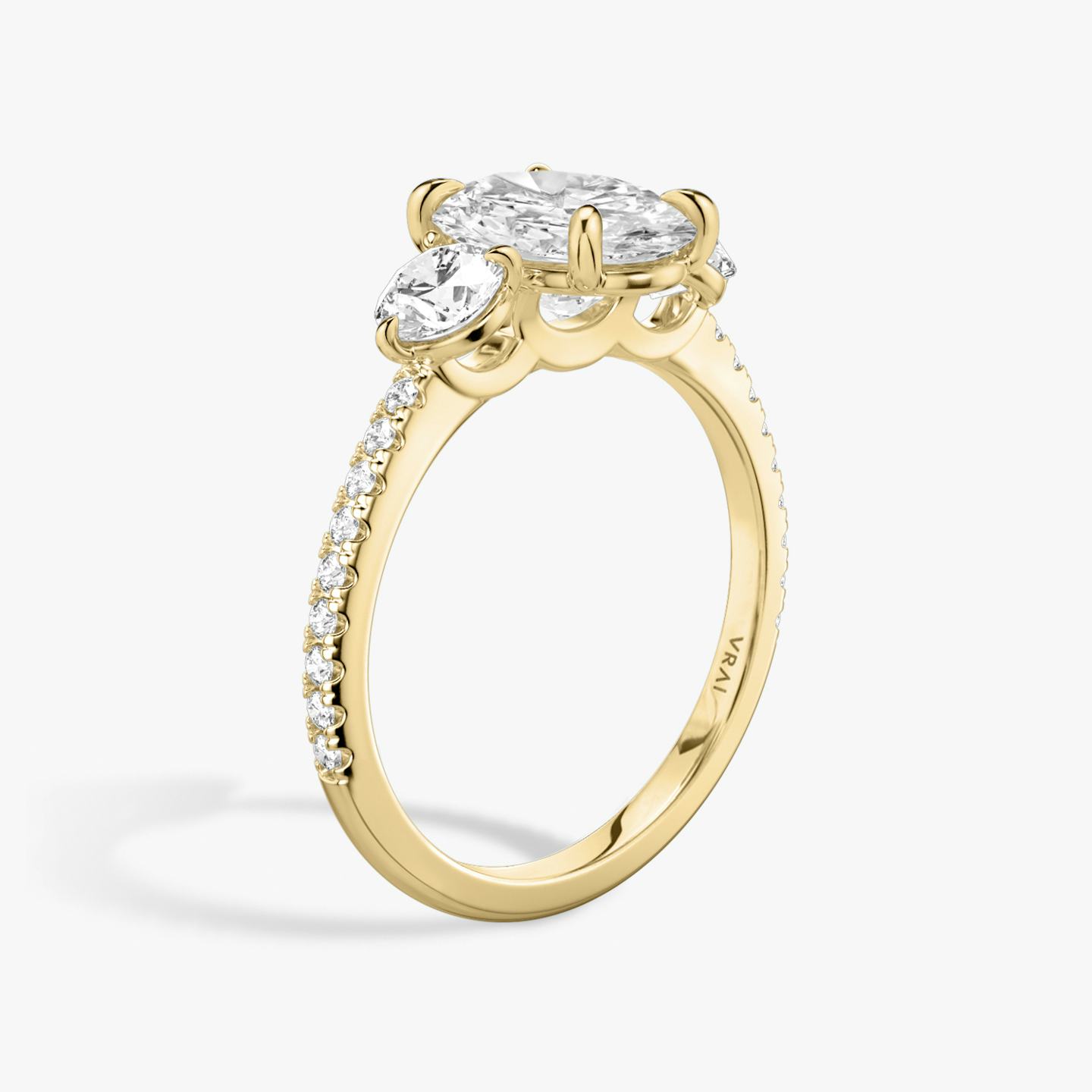 The Three Stone | Oval | 18k | 18k Yellow Gold | Band: Pavé | Side stone carat: 1/4 | Side stone shape: Round Brilliant | Diamond orientation: vertical | Carat weight: See full inventory