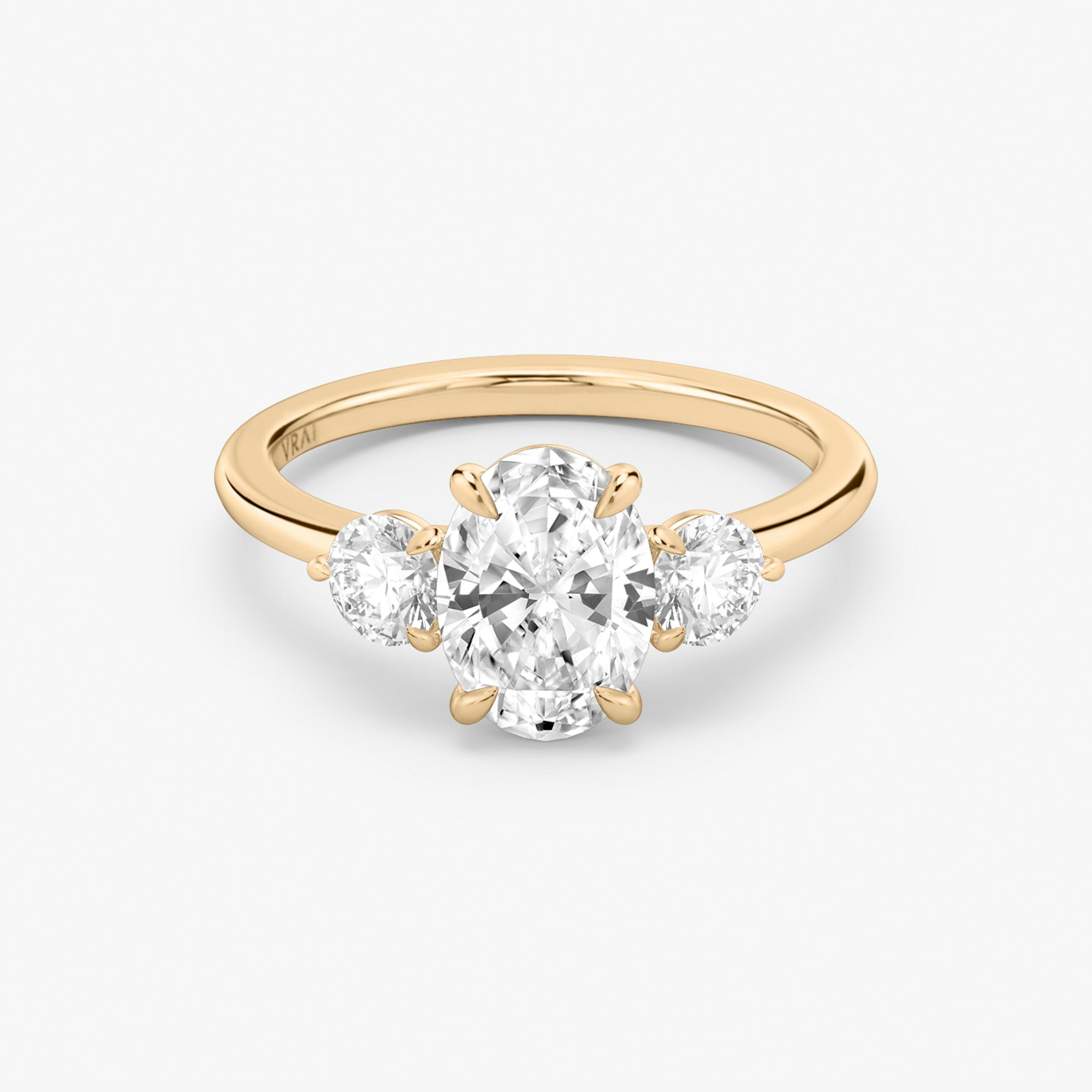 The Three Stone | Oval | 14k | 14k Rose Gold | Band: Plain | Side stone carat: 1/4 | Side stone shape: Round Brilliant | Diamond orientation: vertical | Carat weight: See full inventory