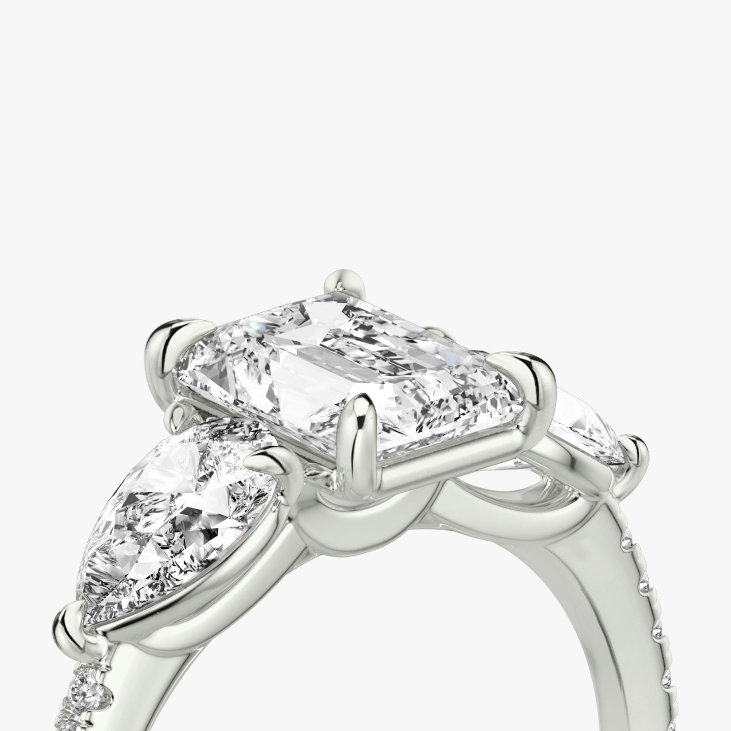The Three Stone | Radiant | 18k | 18k White Gold | Band: Pavé | Side stone carat: 1/2 | Side stone shape: Pear | Diamond orientation: vertical | Carat weight: See full inventory