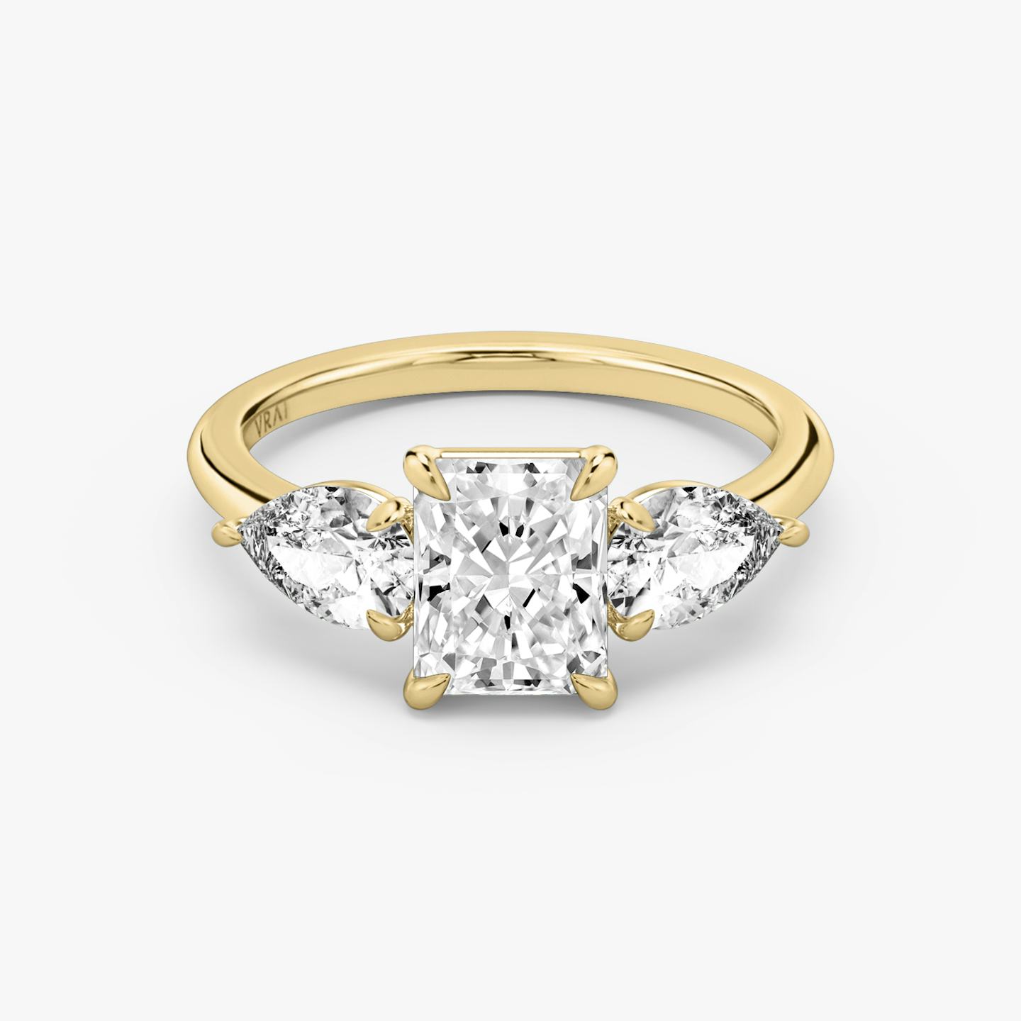 The Three Stone | Radiant | 18k | 18k Yellow Gold | Band: Plain | Side stone carat: 1/2 | Side stone shape: Pear | Diamond orientation: vertical | Carat weight: See full inventory