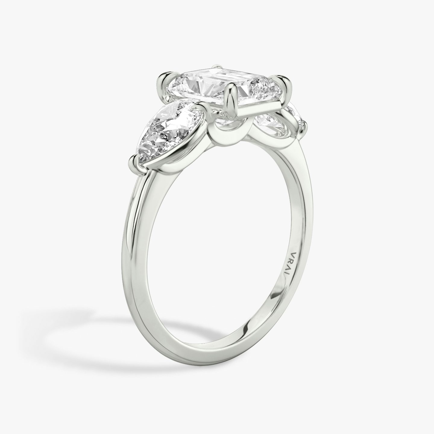 The Three Stone | Radiant | 18k | 18k White Gold | Band: Plain | Side stone carat: 1/2 | Side stone shape: Pear | Diamond orientation: vertical | Carat weight: See full inventory