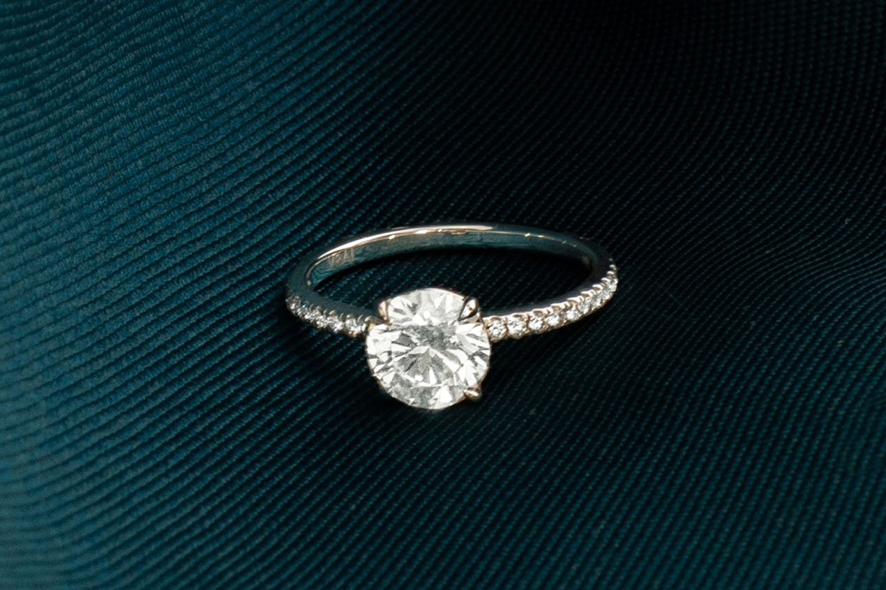 The round brilliant signature engagement ring with pave band 