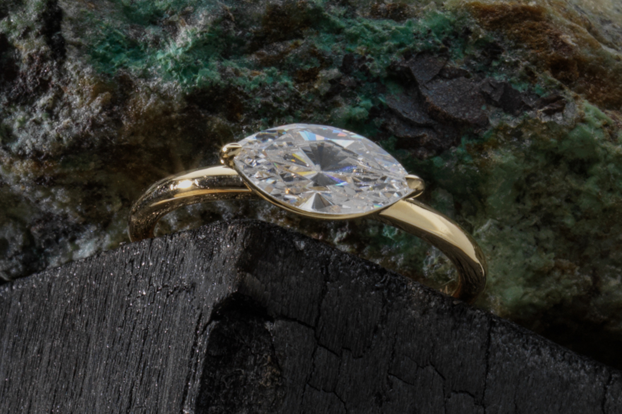 The marquise signature east west engagement ring with yellow gold band