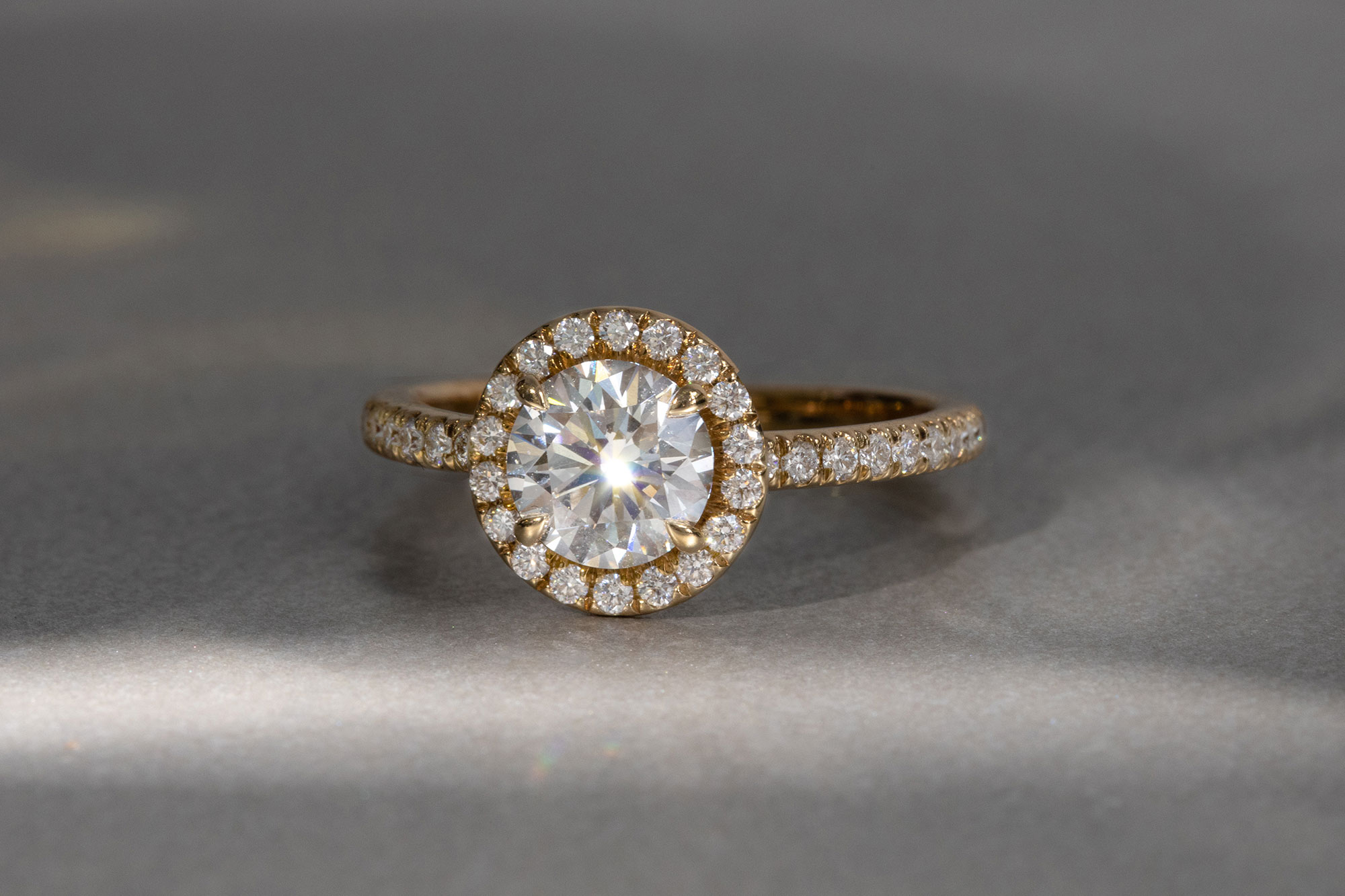 the round brilliant halo engagement ring with yellow gold pave band