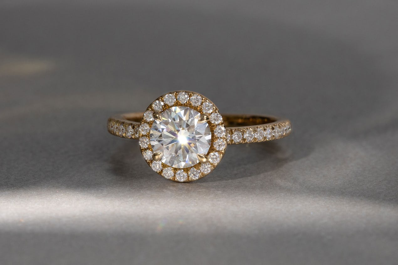 the round brilliant halo engagement ring with yellow gold pave band 
