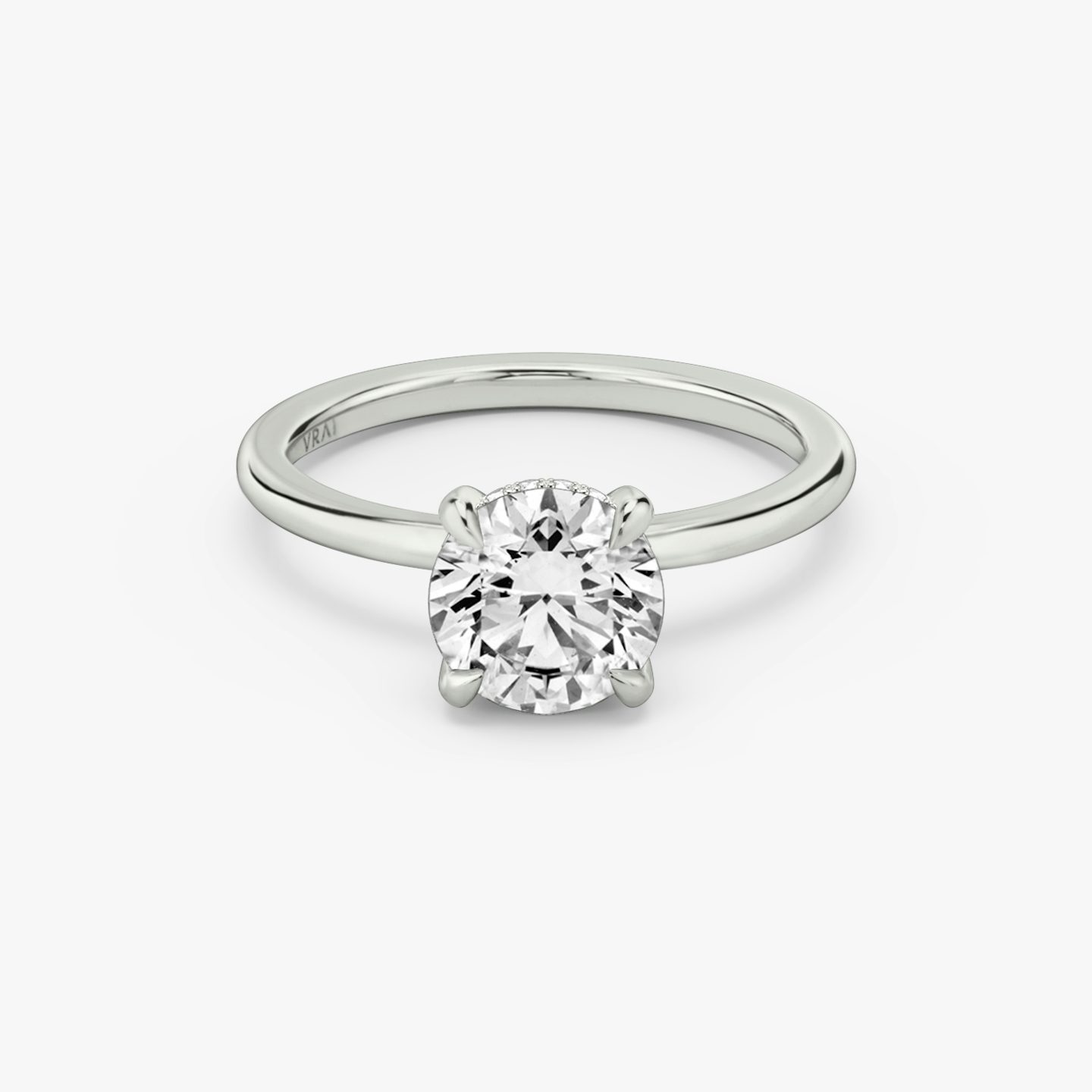 The Classic Hidden Halo | Round Brilliant | Platinum | Band: Plain | Carat weight: See full inventory | Prong style: Plain | Diamond orientation: vertical