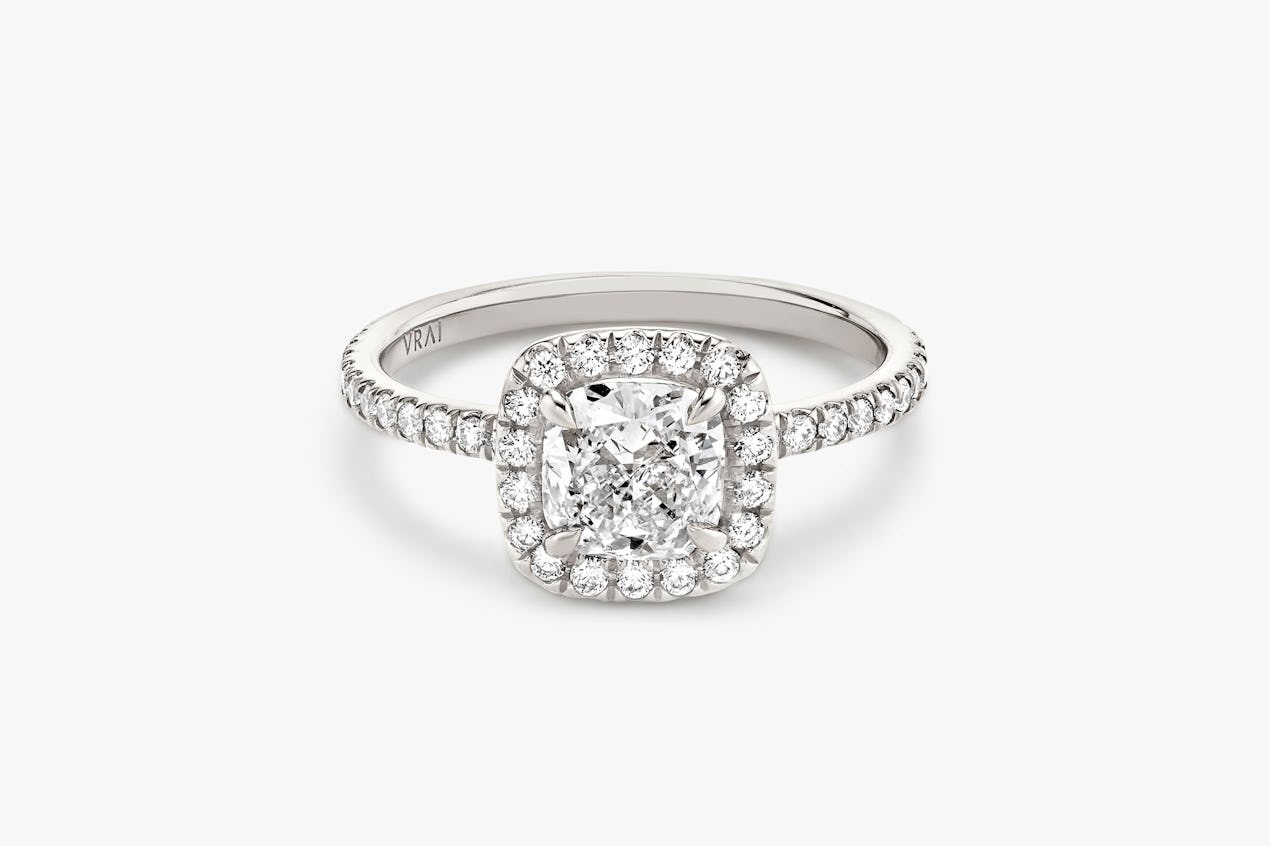 halo ring in platinum with cushion cut diamond and pave band