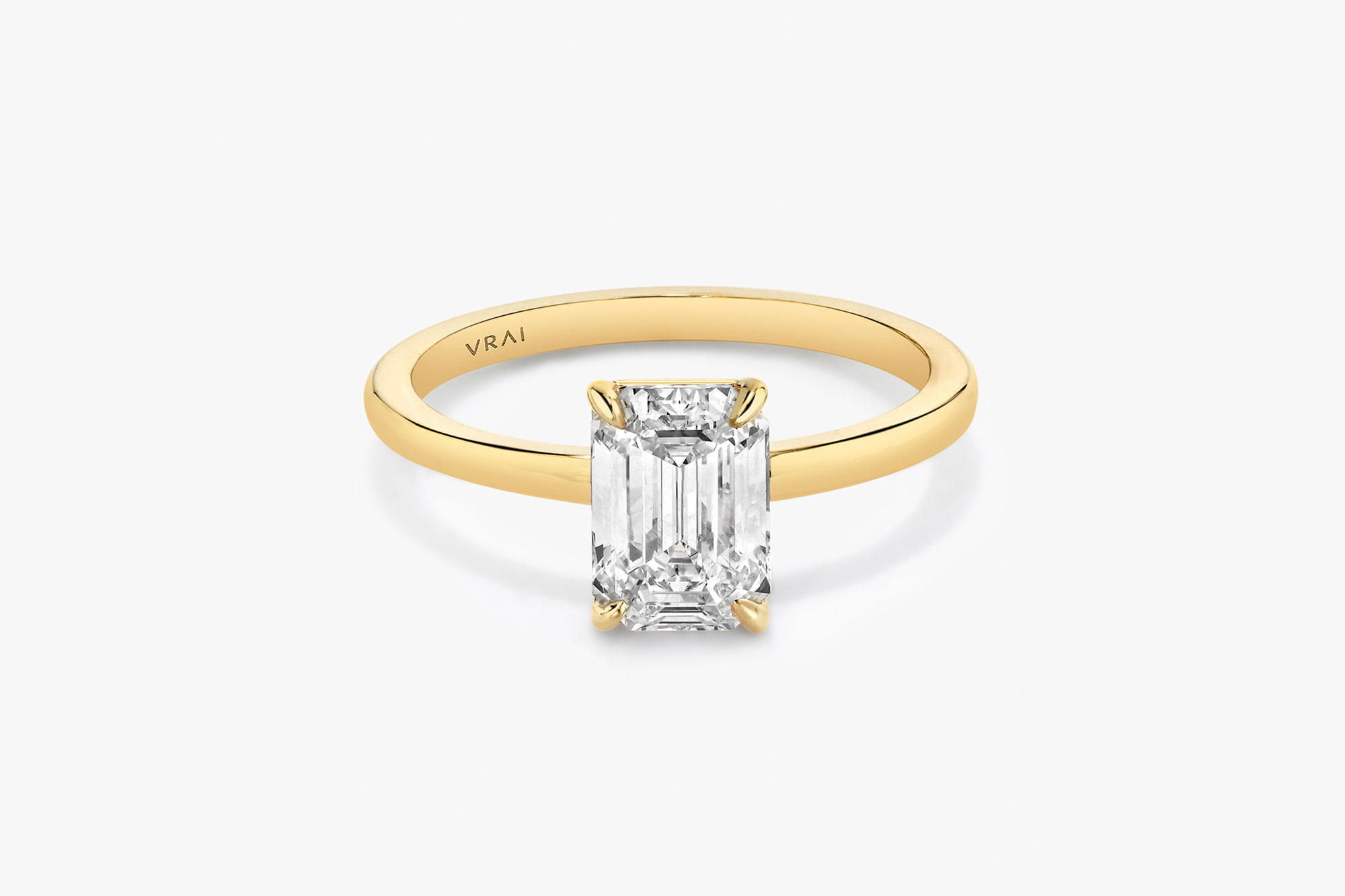 The Signature solitaire ring in 18k yellow gold with an emerald cut diamond