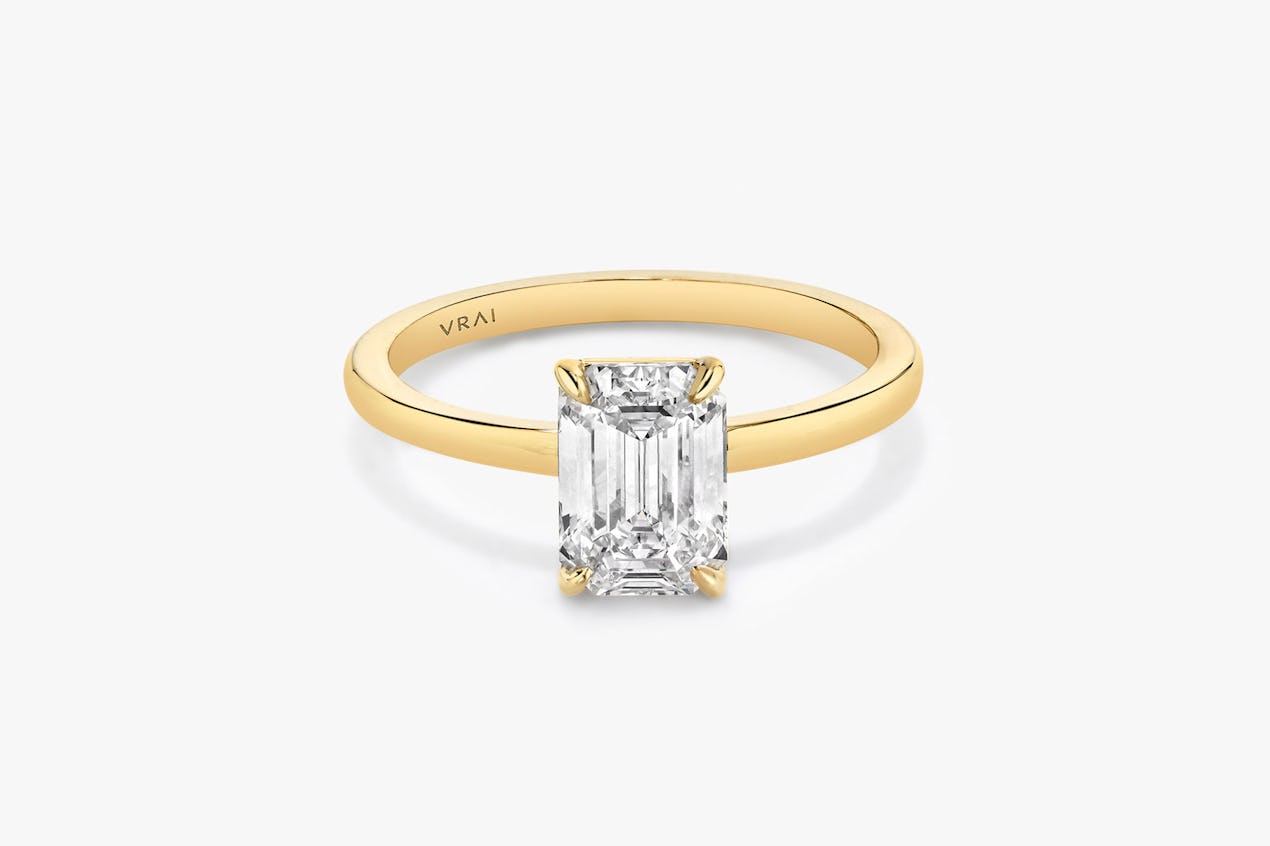 The Signature solitaire ring in 18k yellow gold with an emerald cut diamond