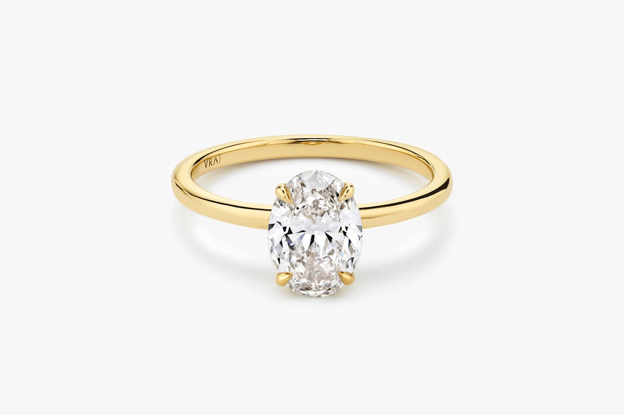 The Signature solitaire ring in 18k yellow gold with an oval cut diamond
