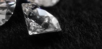 Loose sustainably created lab-grown diamonds on black background