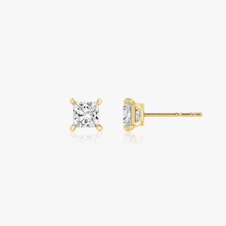 Two studs with a princess cut diamond in yellow gold side view