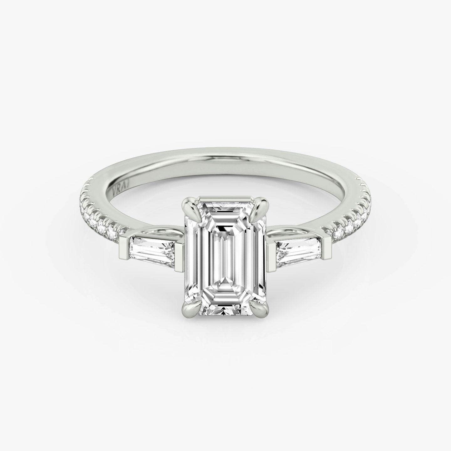 The Three Stone | Emerald | 18k | 18k White Gold | Band: Pavé | Side stone carat: 1/10 | Side stone shape: Tapered Baguette | Diamond orientation: vertical | Carat weight: See full inventory