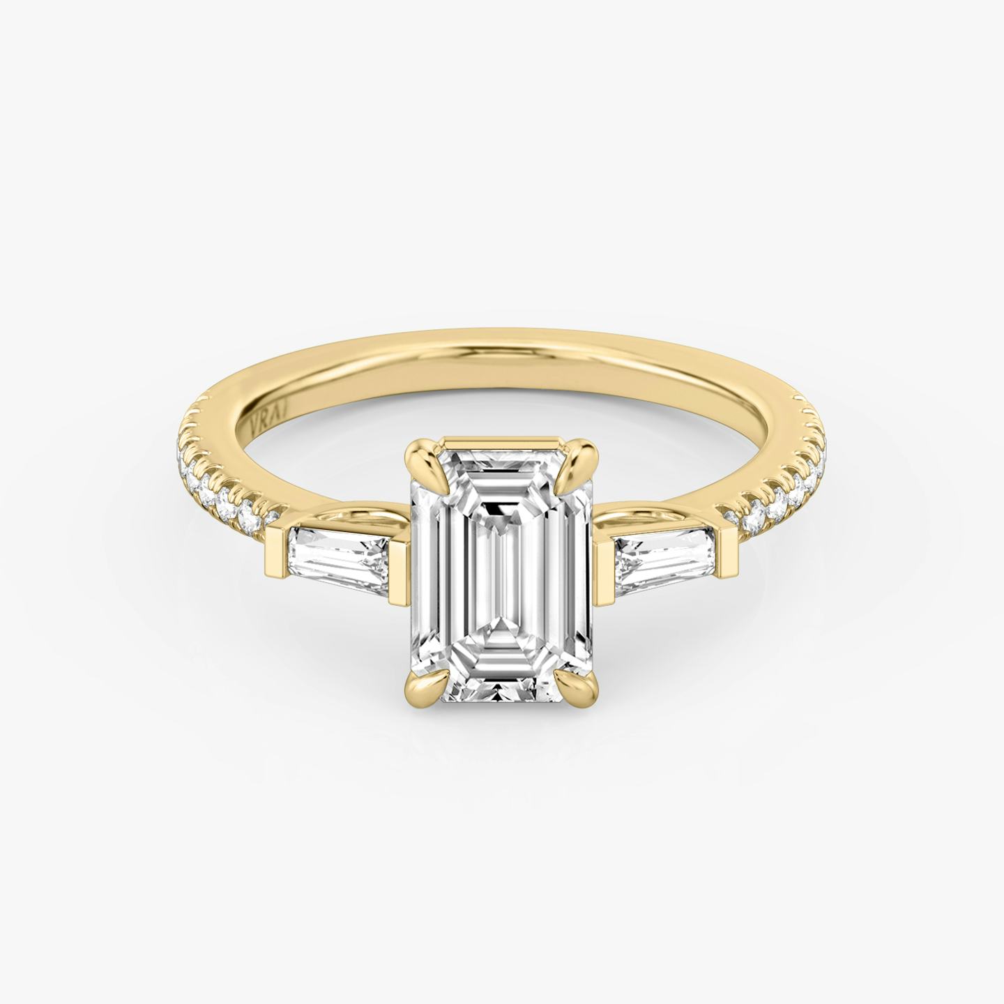 The Three Stone | Emerald | 18k | 18k Yellow Gold | Band: Pavé | Side stone carat: 1/10 | Side stone shape: Tapered Baguette | Diamond orientation: vertical | Carat weight: See full inventory