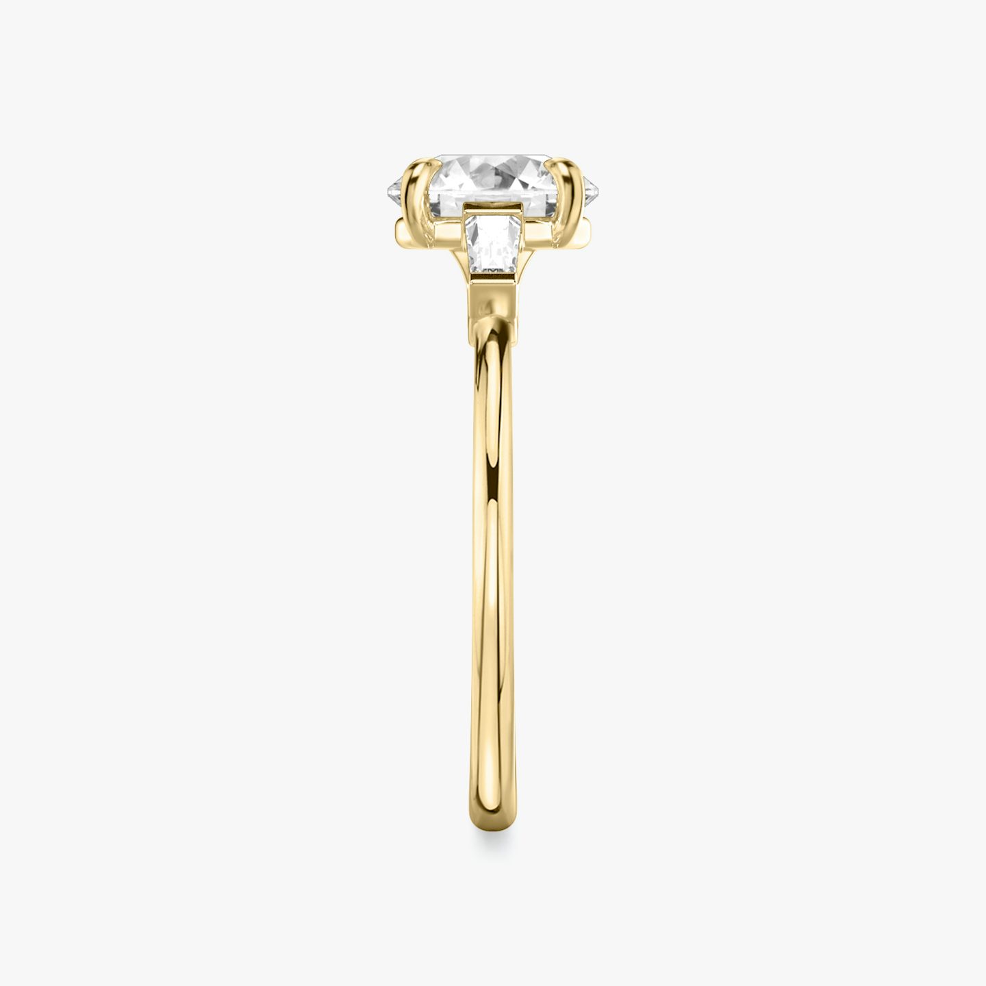 The Three Stone | Round Brilliant | 18k | 18k Yellow Gold | Band: Plain | Carat weight: See full inventory | Side stone carat: 1/10 | Side stone shape: Tapered Baguette | Diamond orientation: vertical