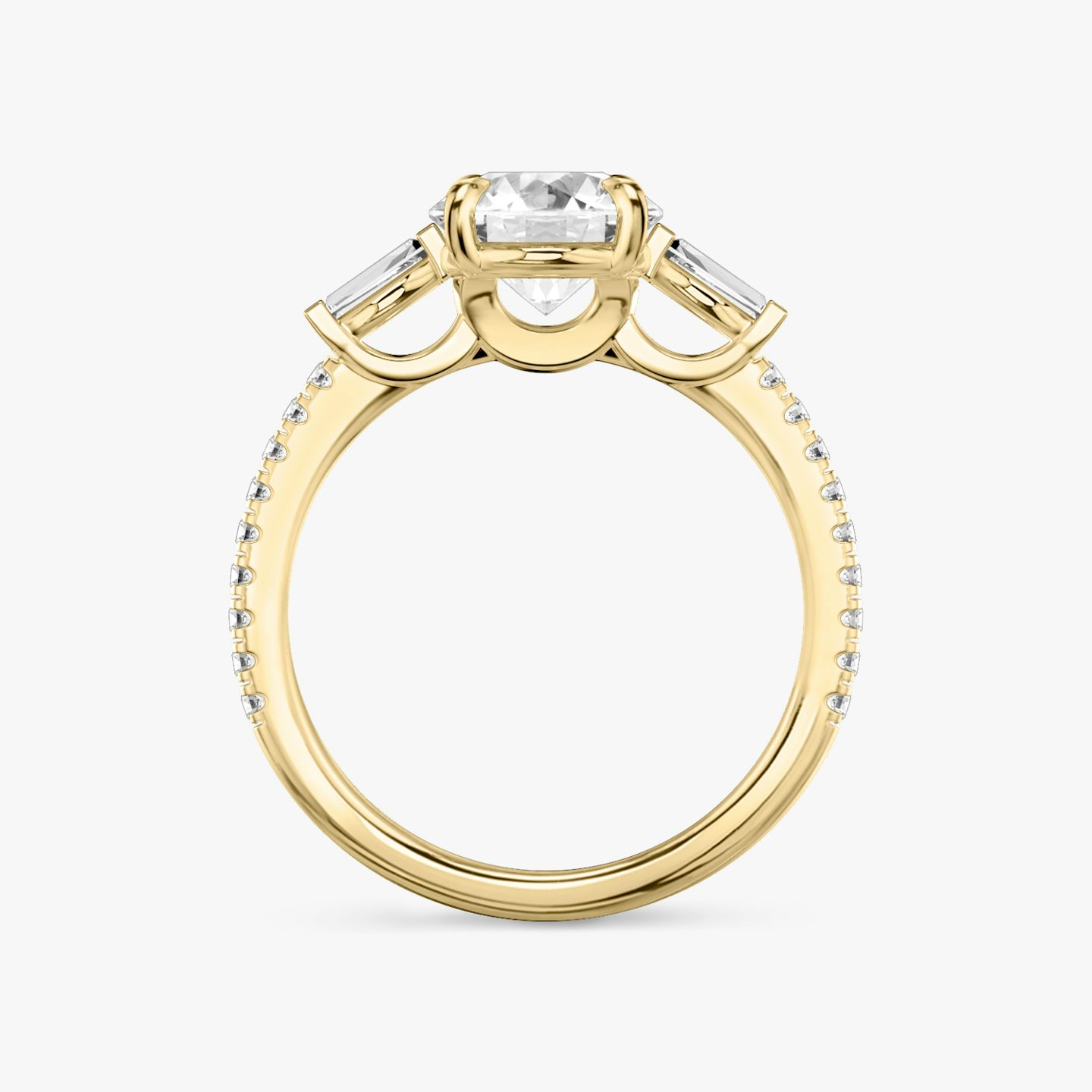 The Three Stone | Round Brilliant | 18k | 18k Yellow Gold | Band: Pavé | Carat weight: See full inventory | Side stone carat: 1/10 | Side stone shape: Tapered Baguette | Diamond orientation: vertical