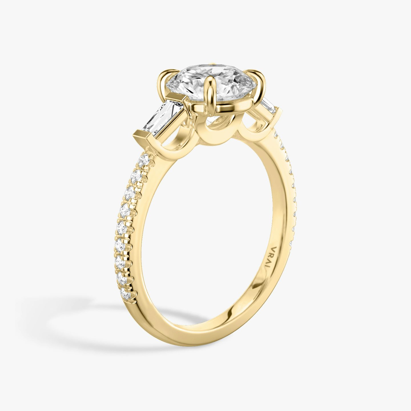The Three Stone | Round Brilliant | 18k | 18k Yellow Gold | Band: Pavé | Carat weight: 1 | Side stone carat: 1/10 | Side stone shape: Tapered Baguette | Diamond orientation: vertical