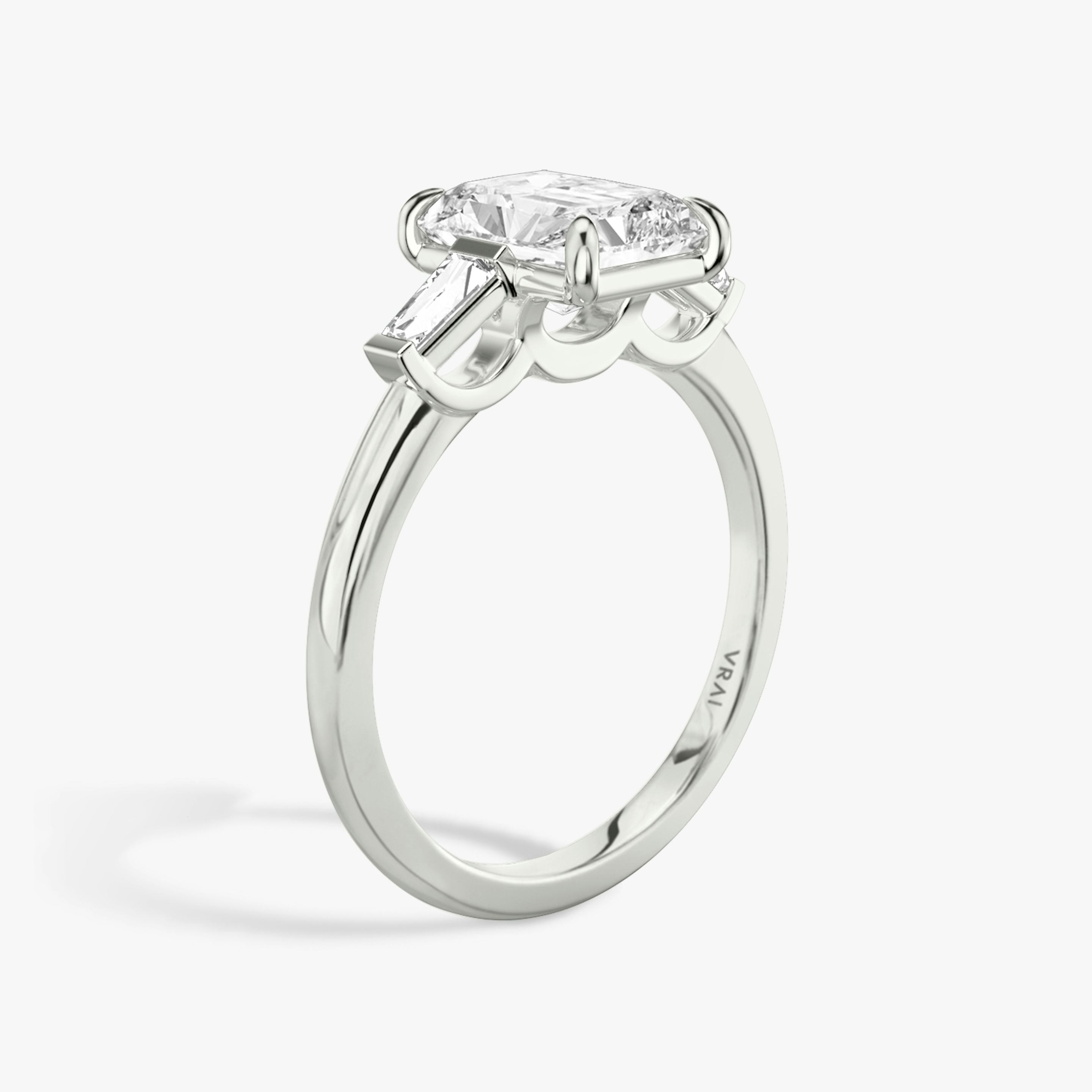 The Three Stone | Radiant | Platinum | Band: Plain | Side stone carat: 1/10 | Side stone shape: Tapered Baguette | Diamond orientation: vertical | Carat weight: See full inventory