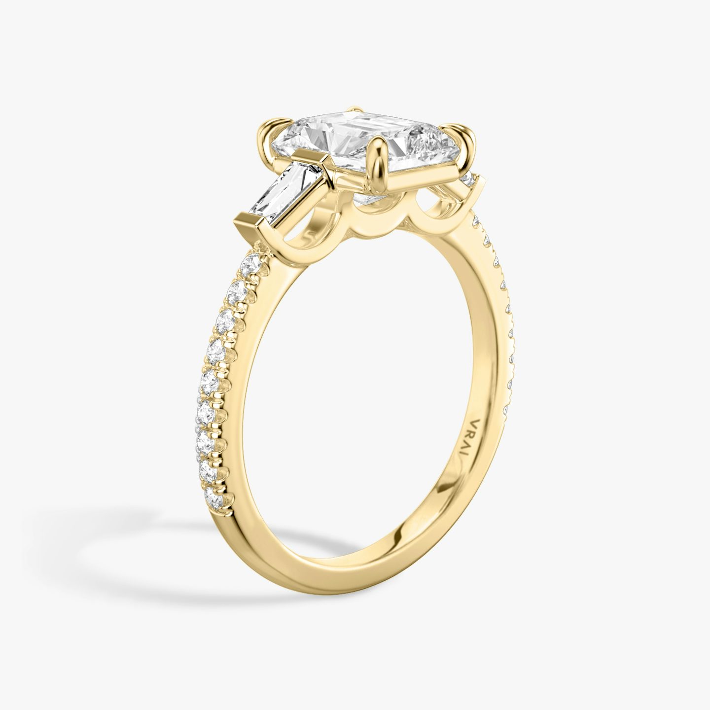 The Three Stone | Radiant | 18k | 18k Yellow Gold | Band: Pavé | Side stone carat: 1/10 | Side stone shape: Tapered Baguette | Diamond orientation: vertical | Carat weight: See full inventory
