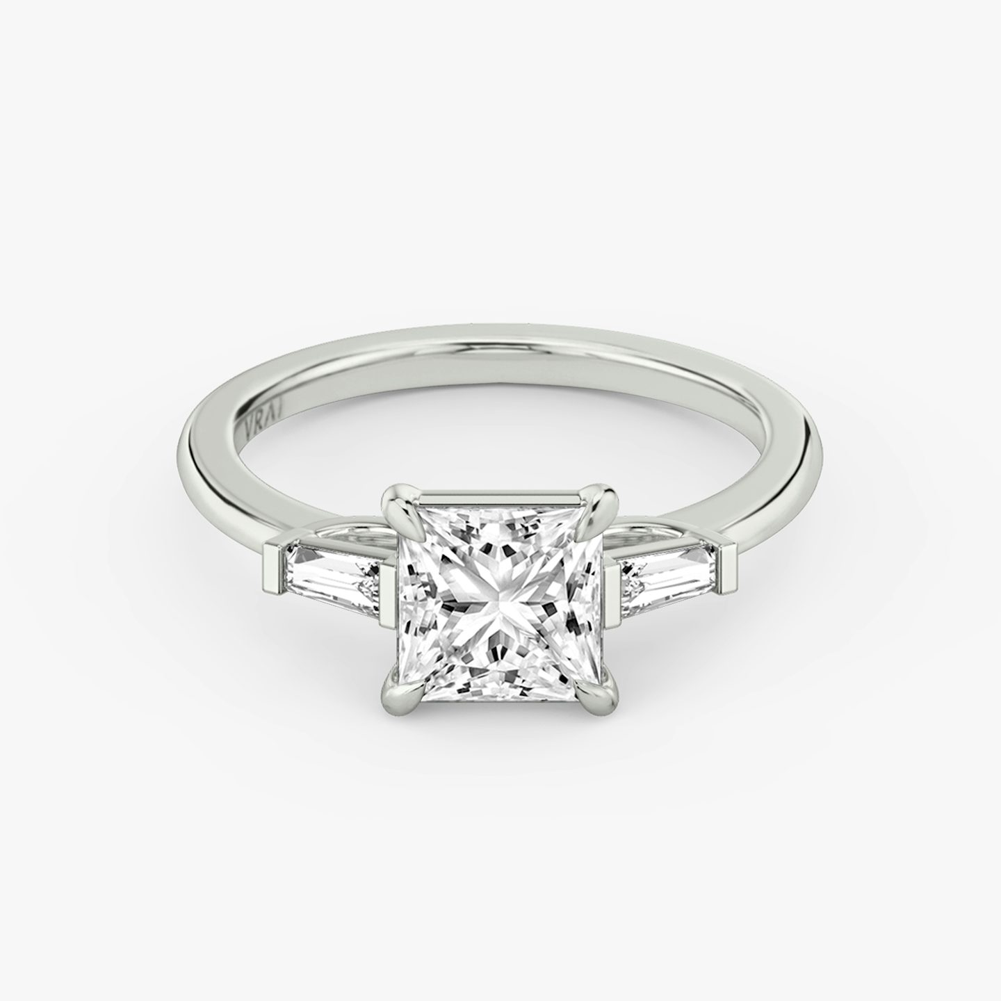 The Three Stone | Princess | 18k | 18k White Gold | Band: Plain | Side stone carat: 1/10 | Side stone shape: Tapered Baguette | Diamond orientation: vertical | Carat weight: See full inventory