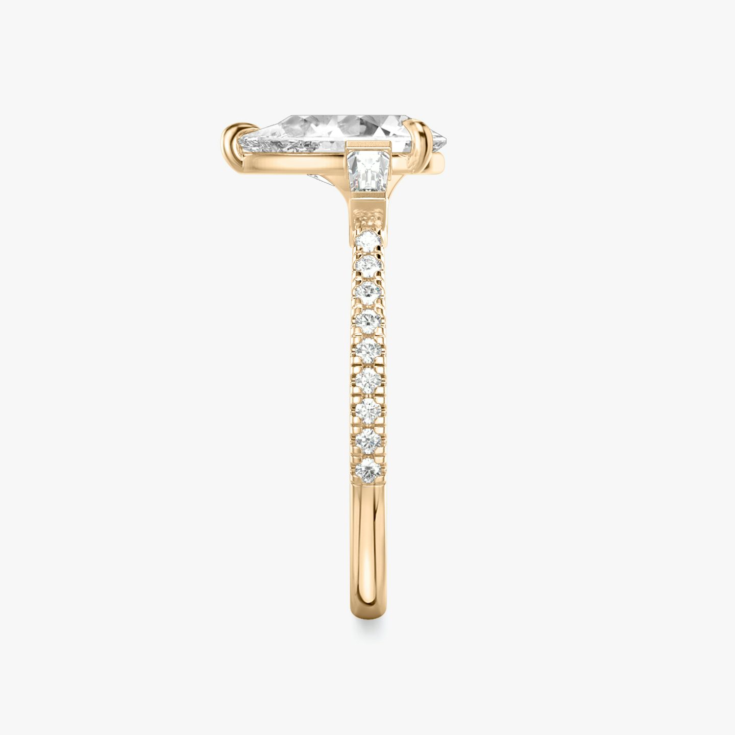 The Three Stone | Pear | 14k | 14k Rose Gold | Band: Pavé | Side stone carat: 1/10 | Side stone shape: Tapered Baguette | Diamond orientation: vertical | Carat weight: See full inventory