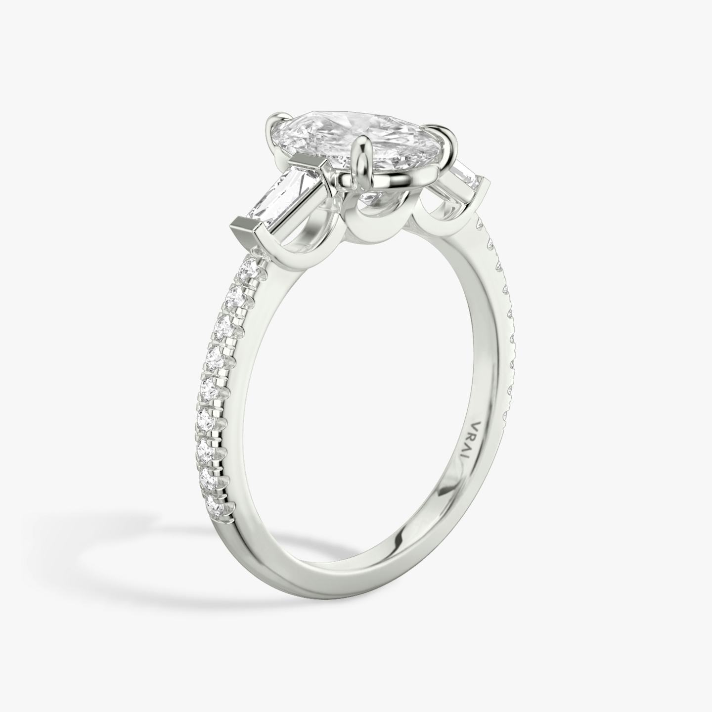 The Three Stone | Pear | Platinum | Band: Pavé | Side stone carat: 1/10 | Side stone shape: Tapered Baguette | Diamond orientation: vertical | Carat weight: See full inventory