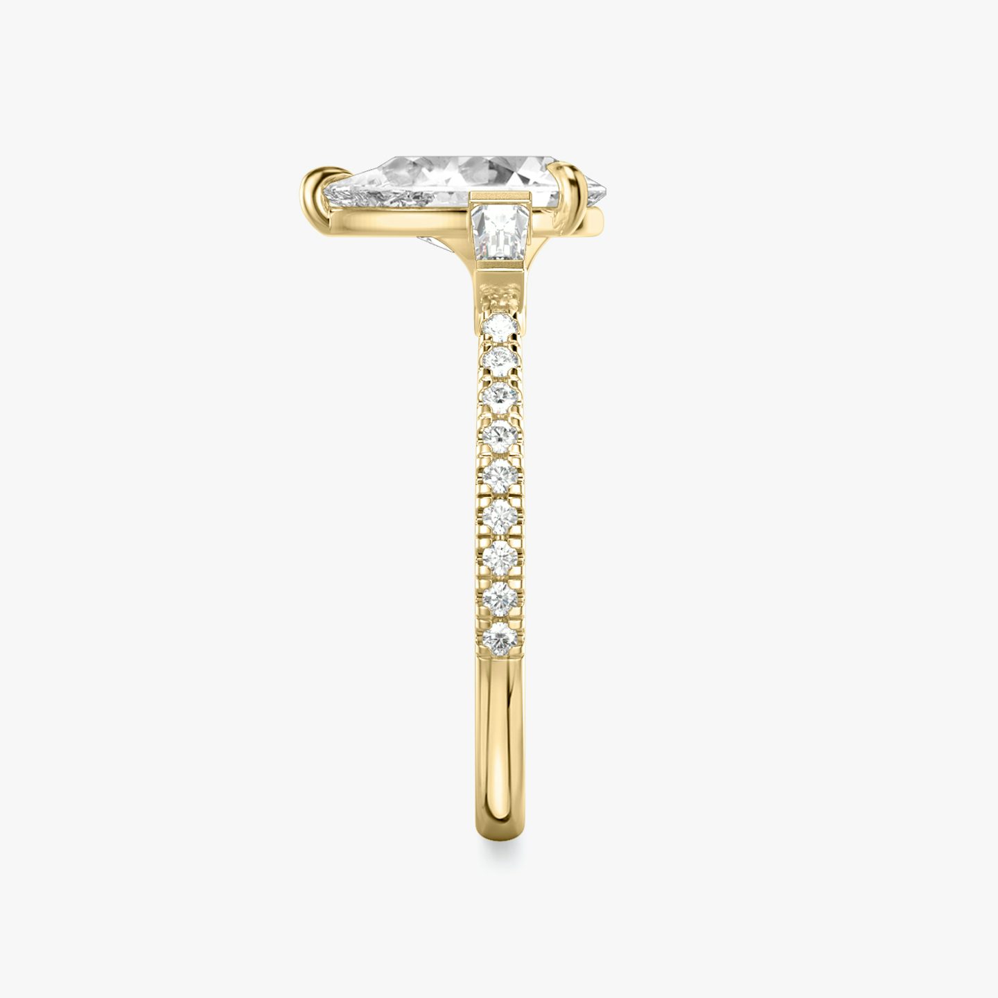 The Three Stone | Pear | 18k | 18k Yellow Gold | Band: Pavé | Side stone carat: 1/10 | Side stone shape: Tapered Baguette | Diamond orientation: vertical | Carat weight: See full inventory