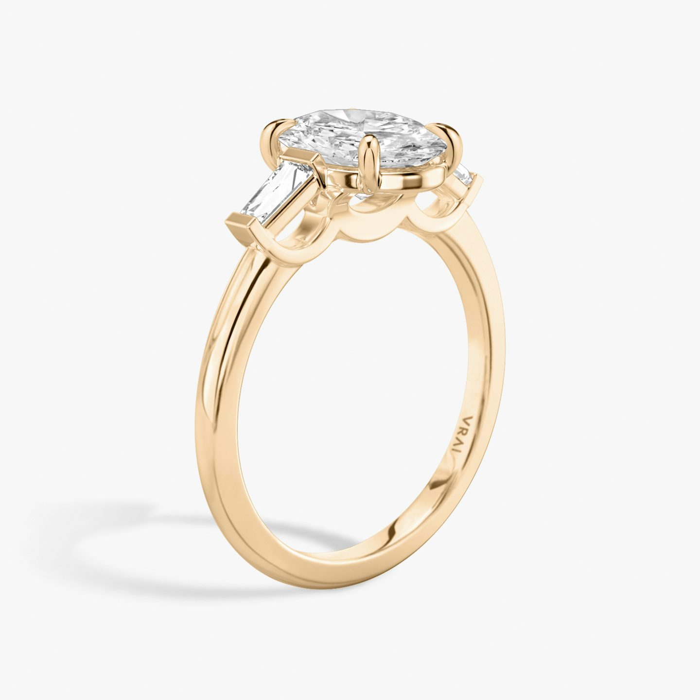 The Three Stone | Oval | 14k | 14k Rose Gold | Band: Plain | Side stone carat: 1/10 | Side stone shape: Tapered Baguette | Diamond orientation: vertical | Carat weight: See full inventory