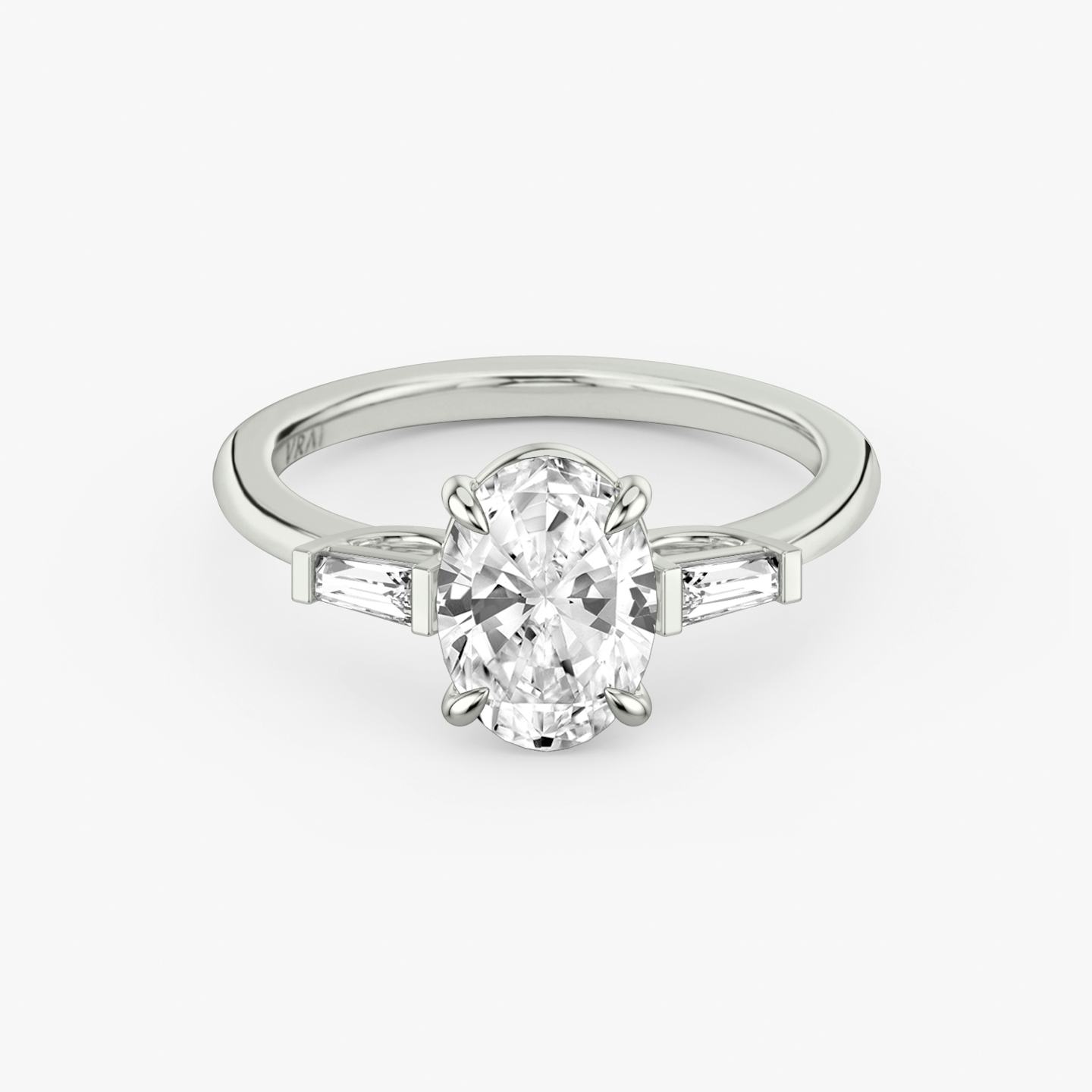 The Three Stone | Oval | Platinum | Band: Plain | Side stone carat: 1/10 | Side stone shape: Tapered Baguette | Diamond orientation: vertical | Carat weight: See full inventory