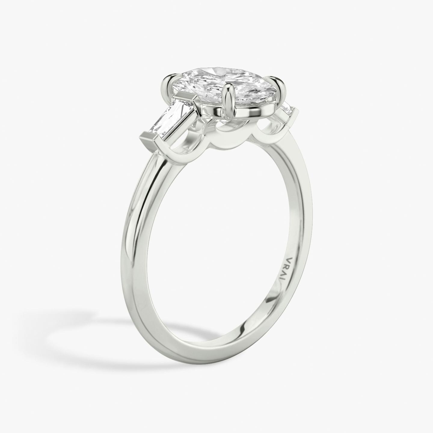 The Three Stone | Oval | Platinum | Band: Plain | Side stone carat: 1/10 | Side stone shape: Tapered Baguette | Diamond orientation: vertical | Carat weight: See full inventory