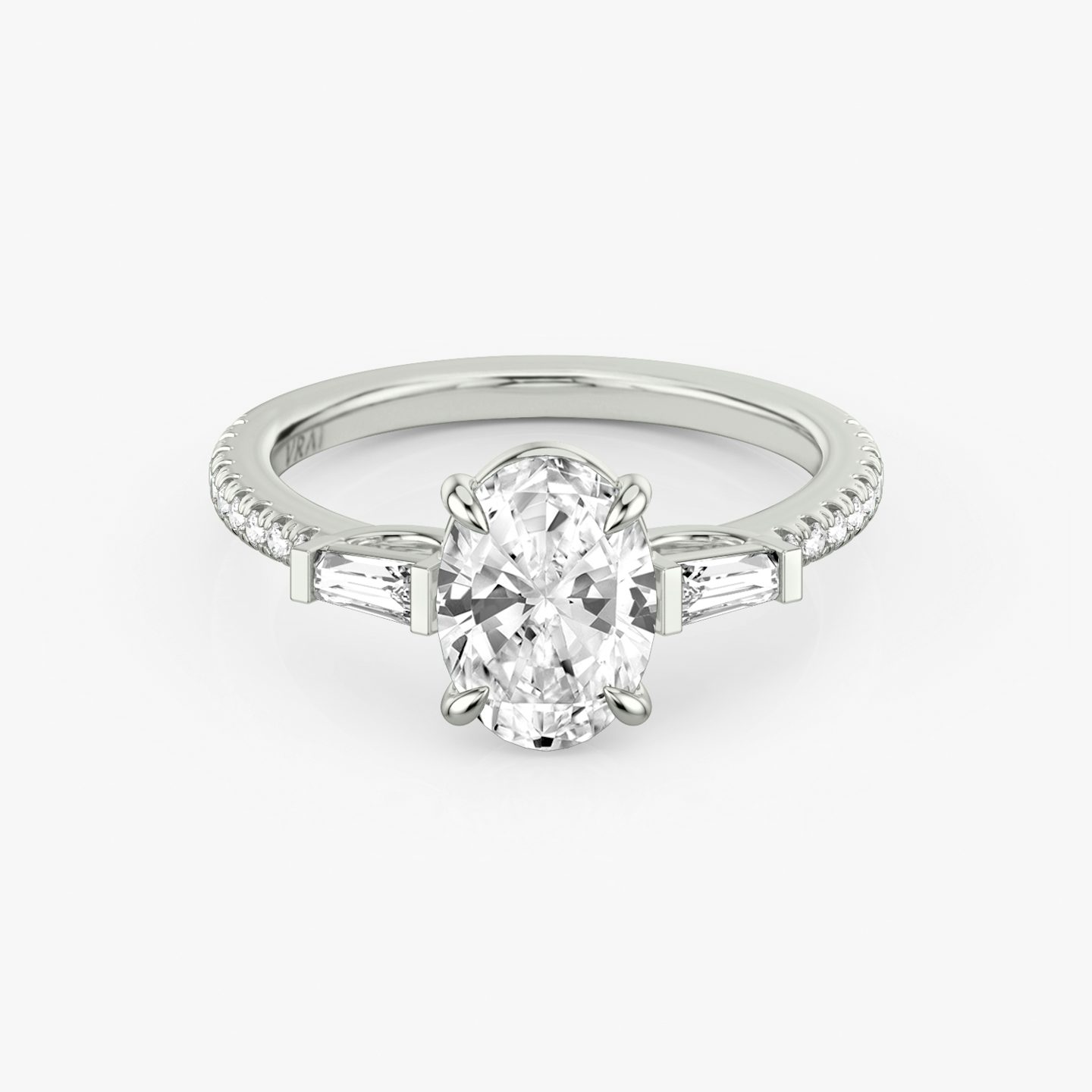 The Three Stone | Oval | 18k | 18k White Gold | Band: Pavé | Side stone carat: 1/10 | Side stone shape: Tapered Baguette | Diamond orientation: vertical | Carat weight: See full inventory