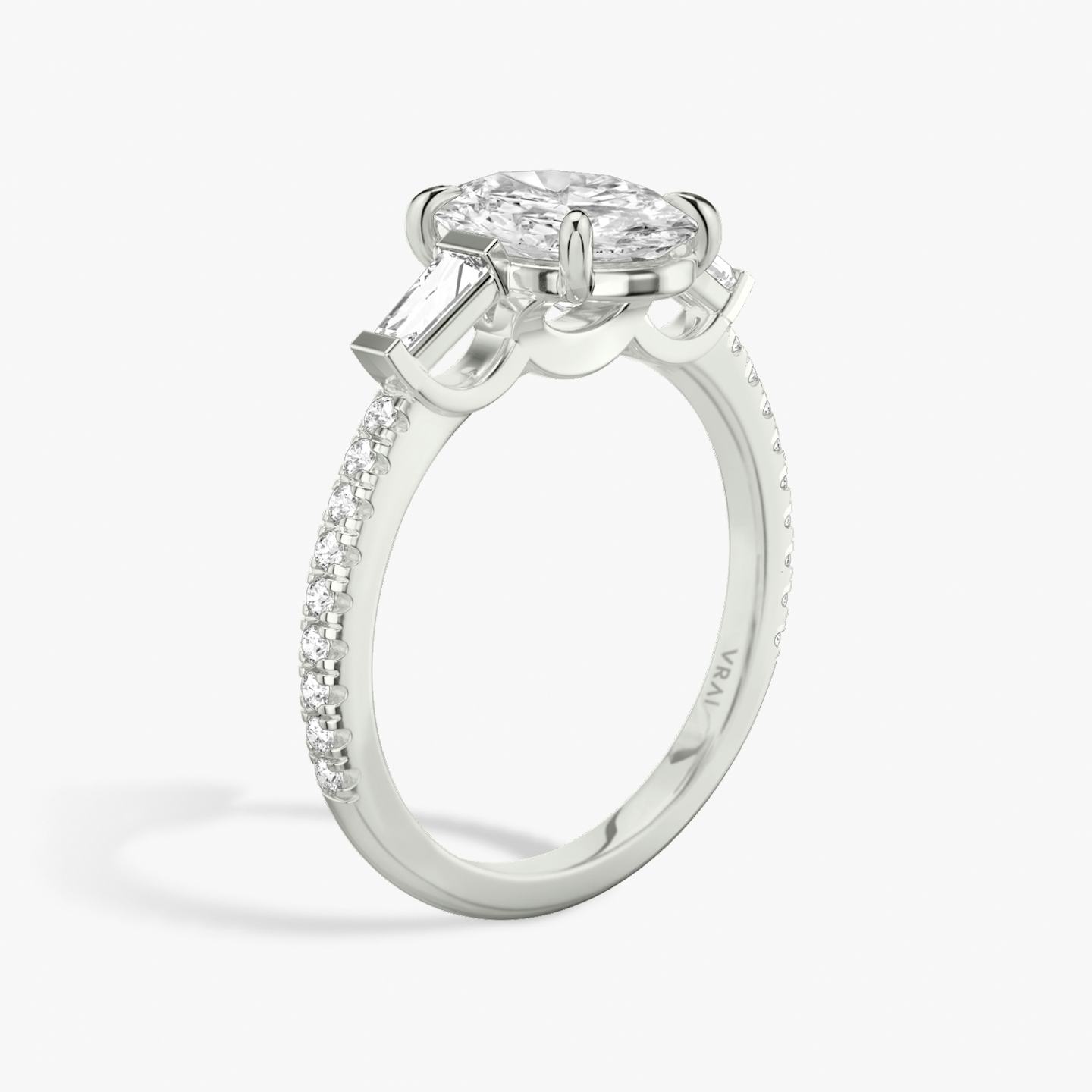 The Three Stone | Oval | Platinum | Band: Pavé | Side stone carat: 1/10 | Side stone shape: Tapered Baguette | Diamond orientation: vertical | Carat weight: See full inventory