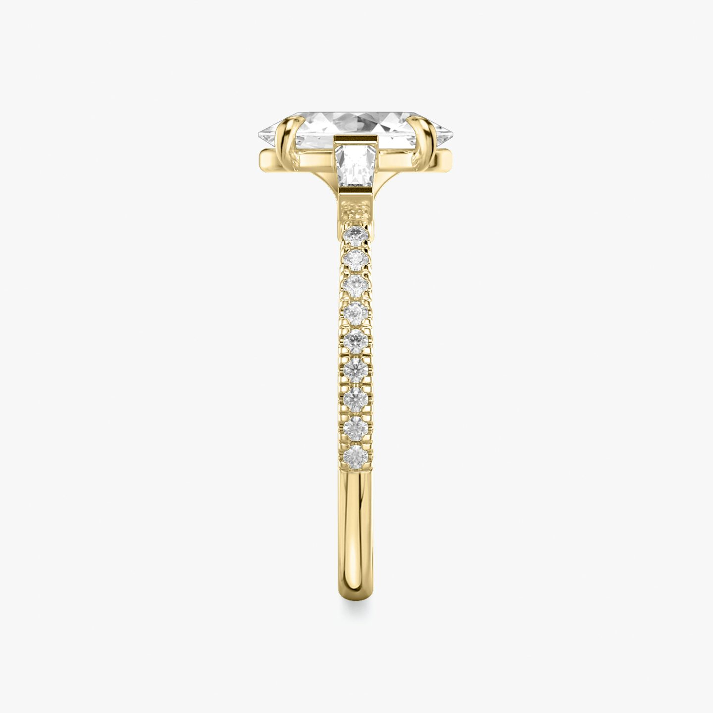 The Three Stone | Oval | 18k | 18k Yellow Gold | Band: Pavé | Side stone carat: 1/10 | Side stone shape: Tapered Baguette | Diamond orientation: vertical | Carat weight: See full inventory